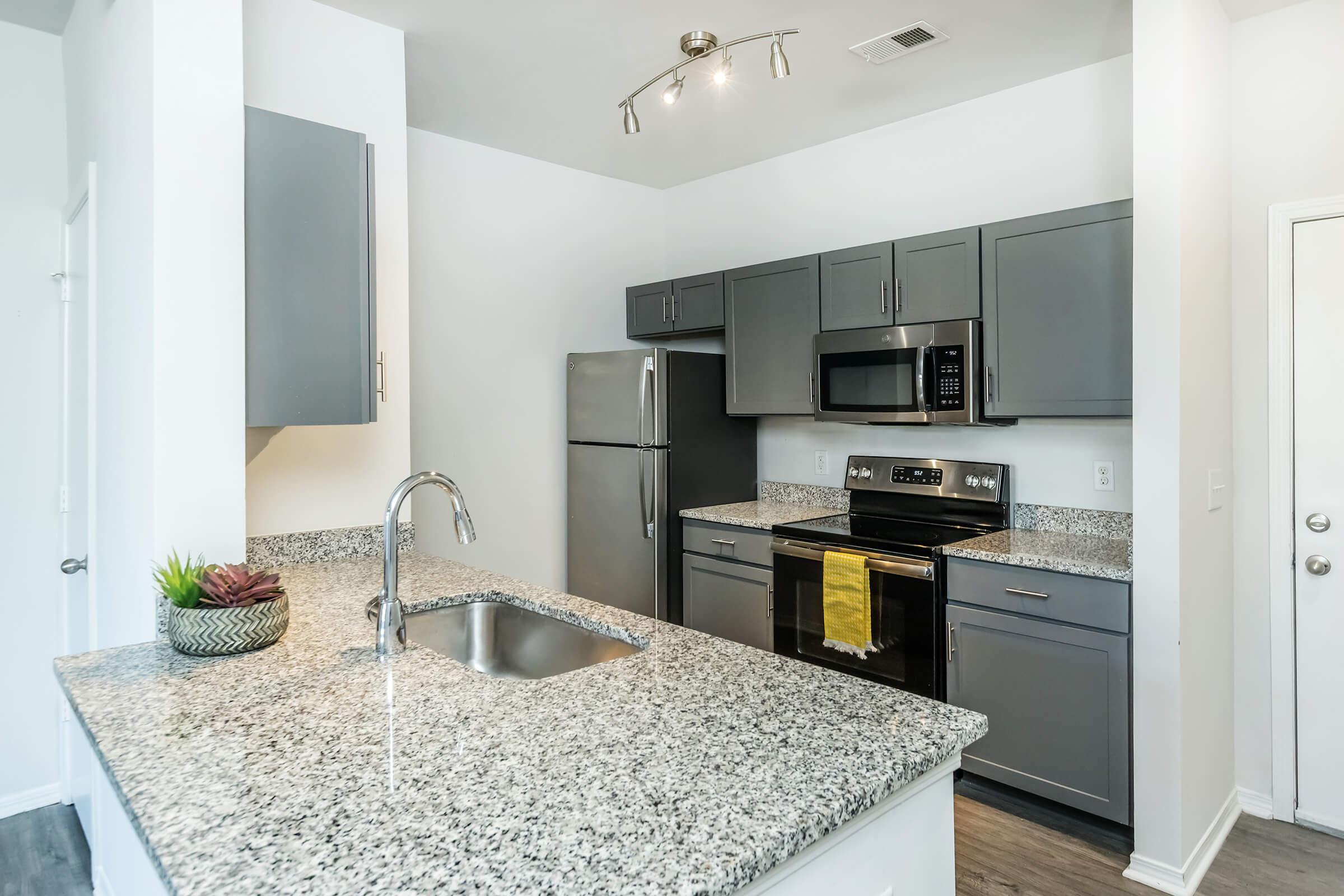 a kitchen with a sink and a mirror