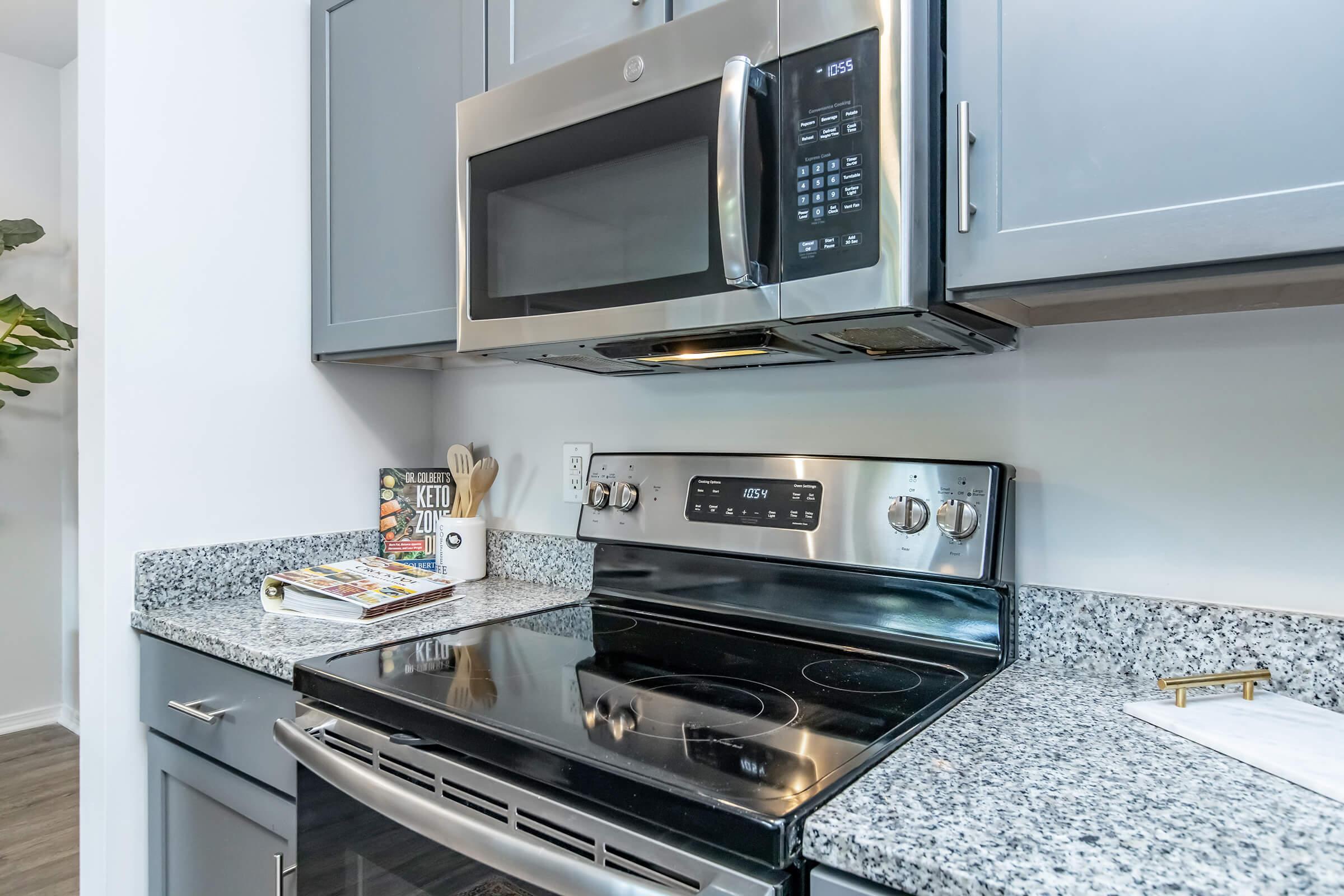 a stove top oven sitting inside of a kitchen