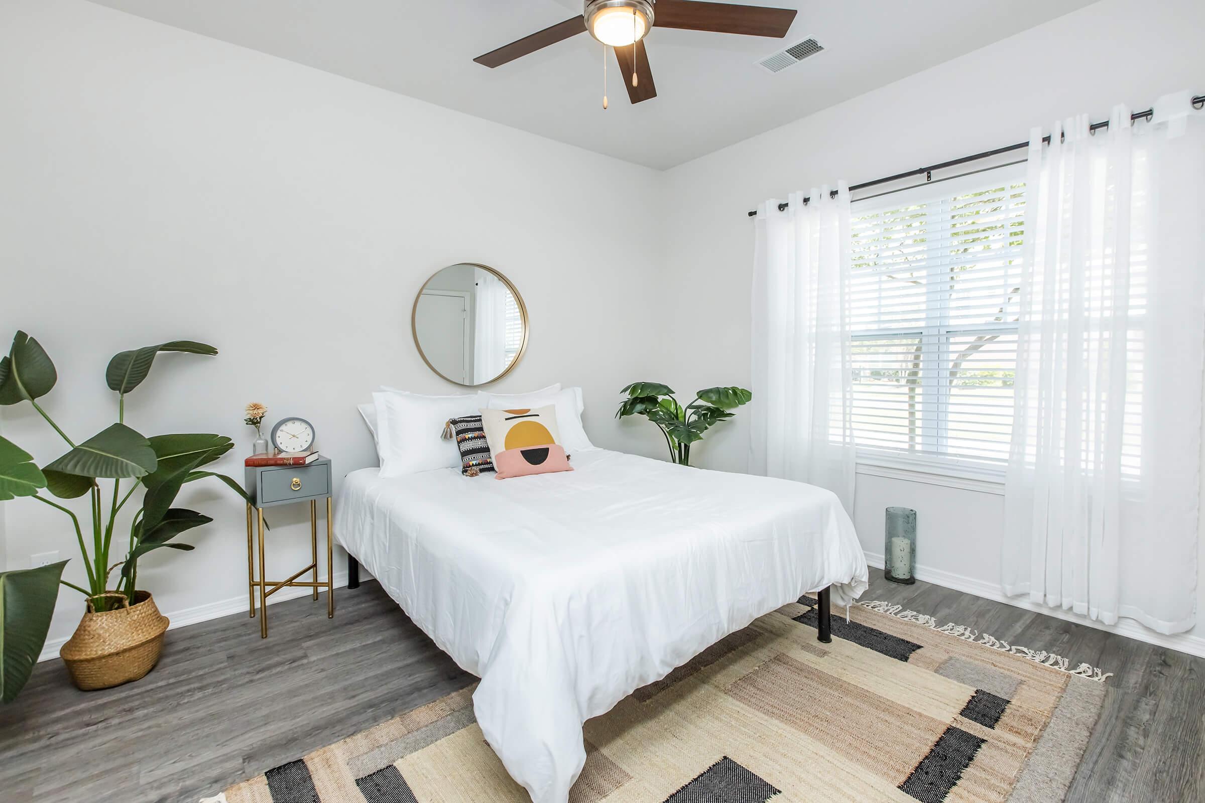 a bedroom with a bed and desk in a room