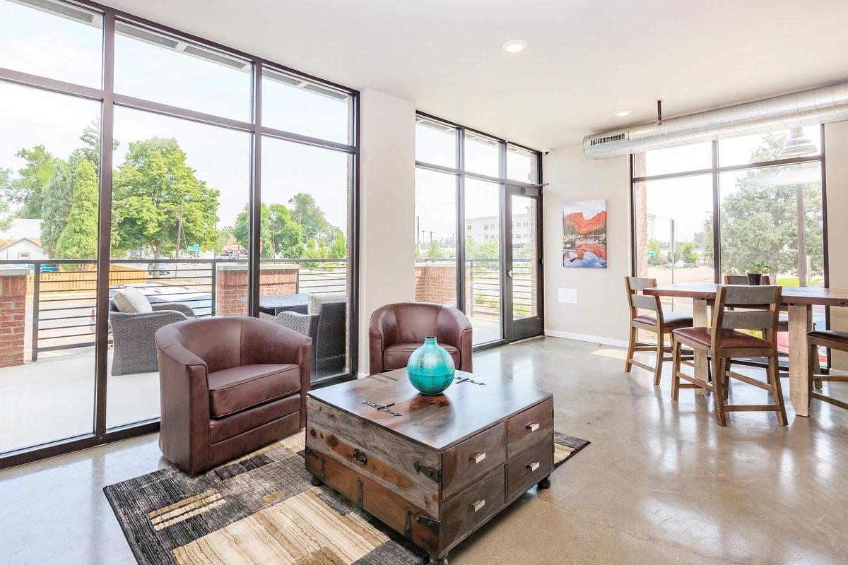 a living room filled with furniture and a large window