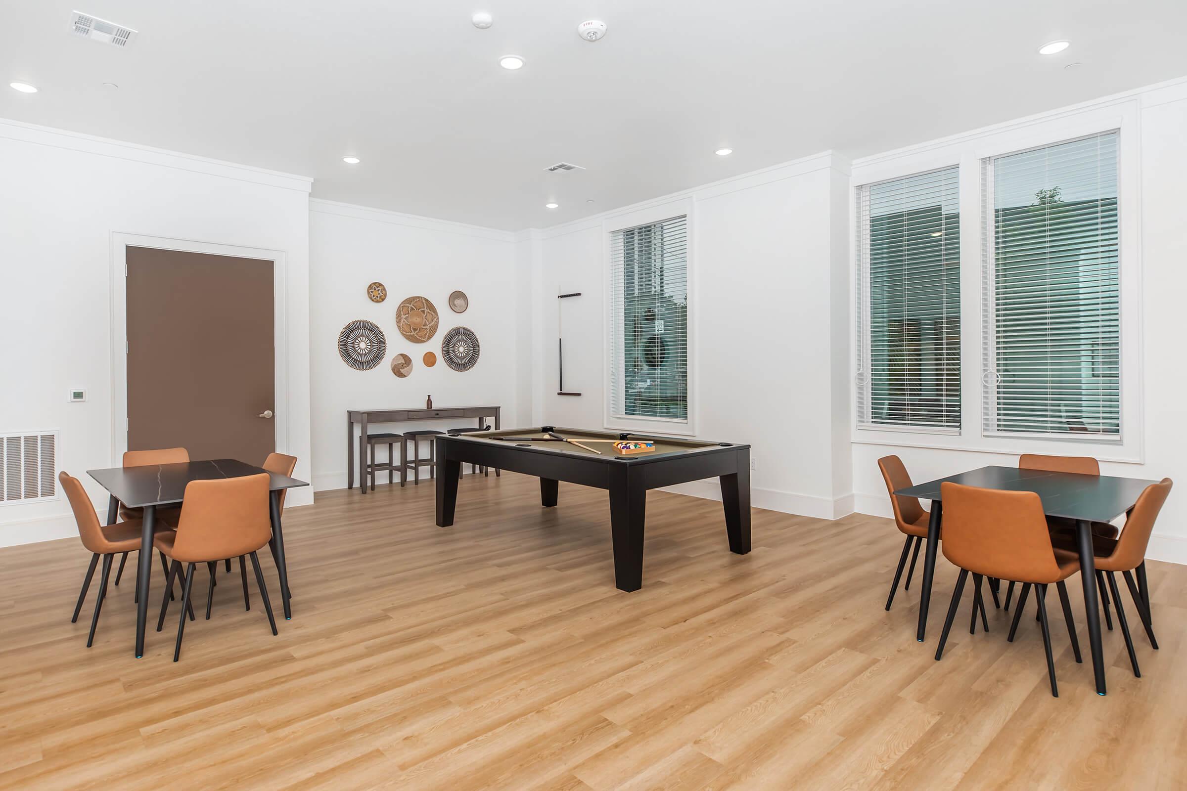 a living room filled with furniture and a large window