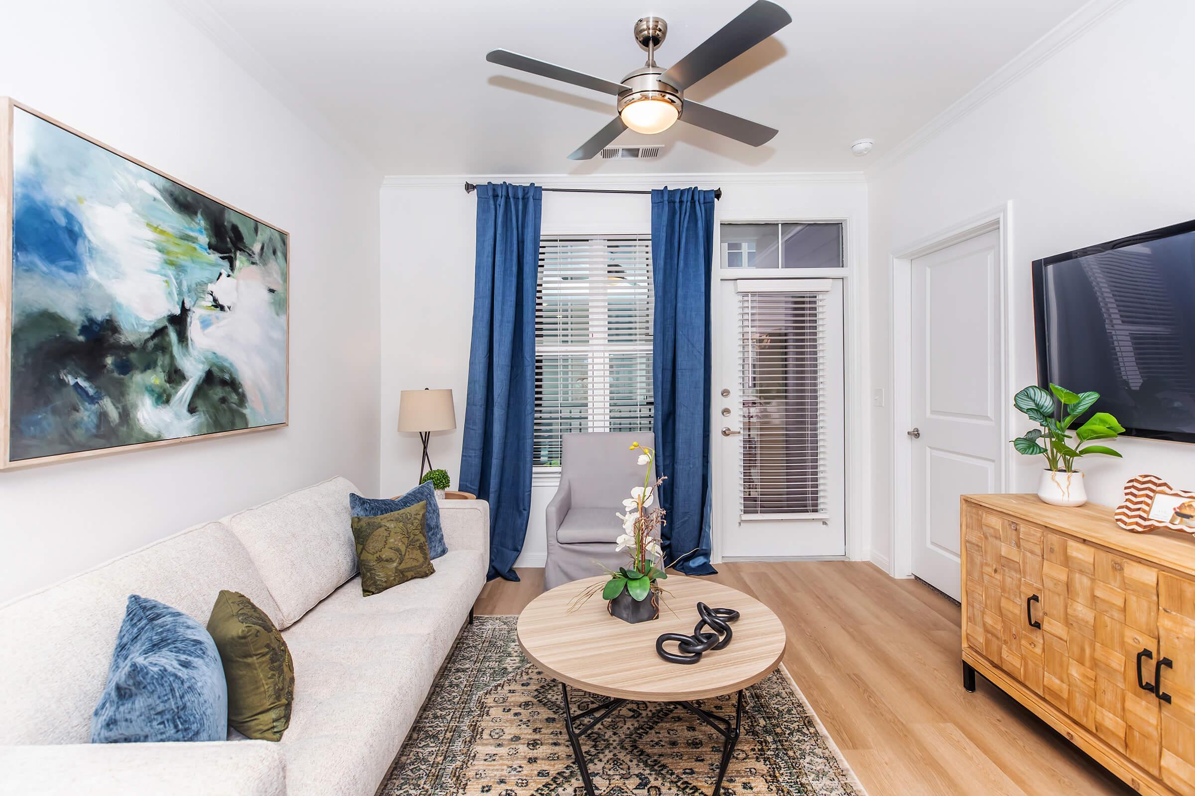 a living room filled with furniture and vase of flowers on a table