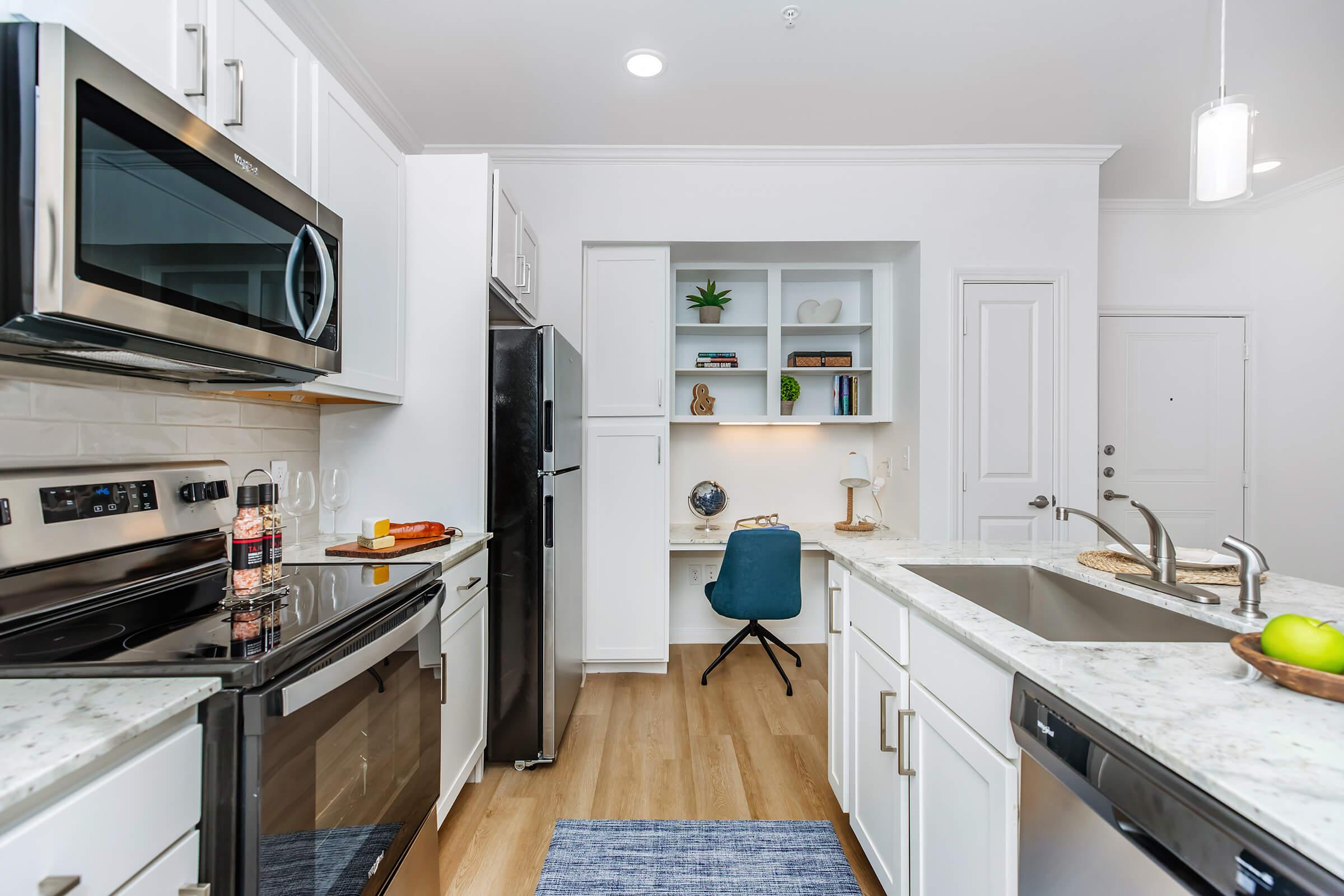 a stove top oven sitting inside of a kitchen