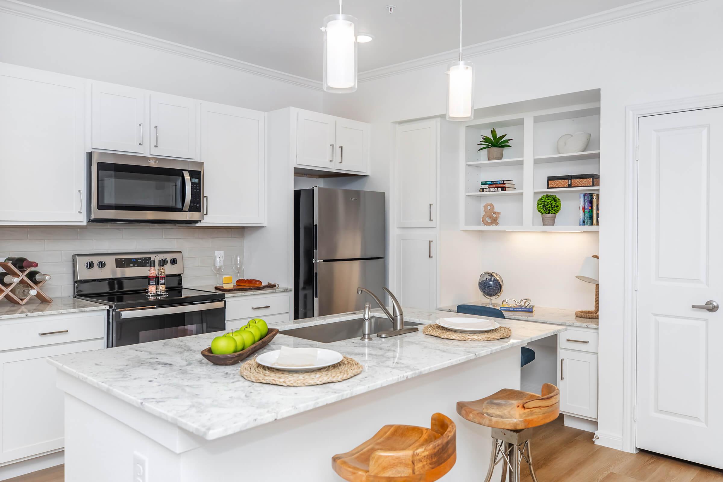 a kitchen with an island in the middle of a room