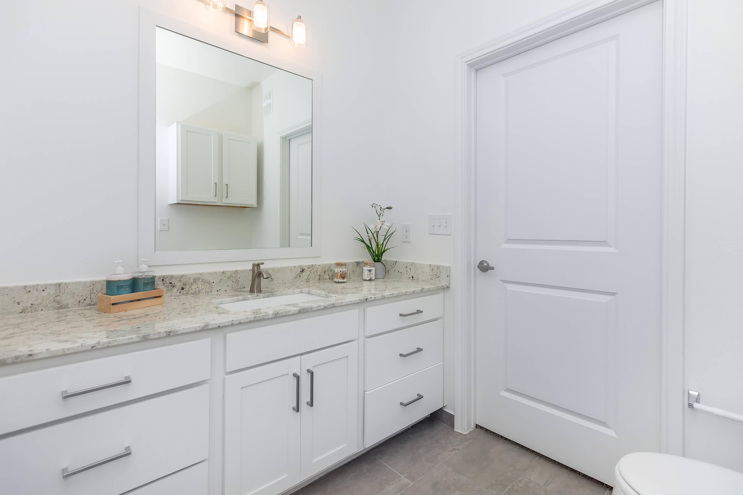 a kitchen with a sink and a mirror