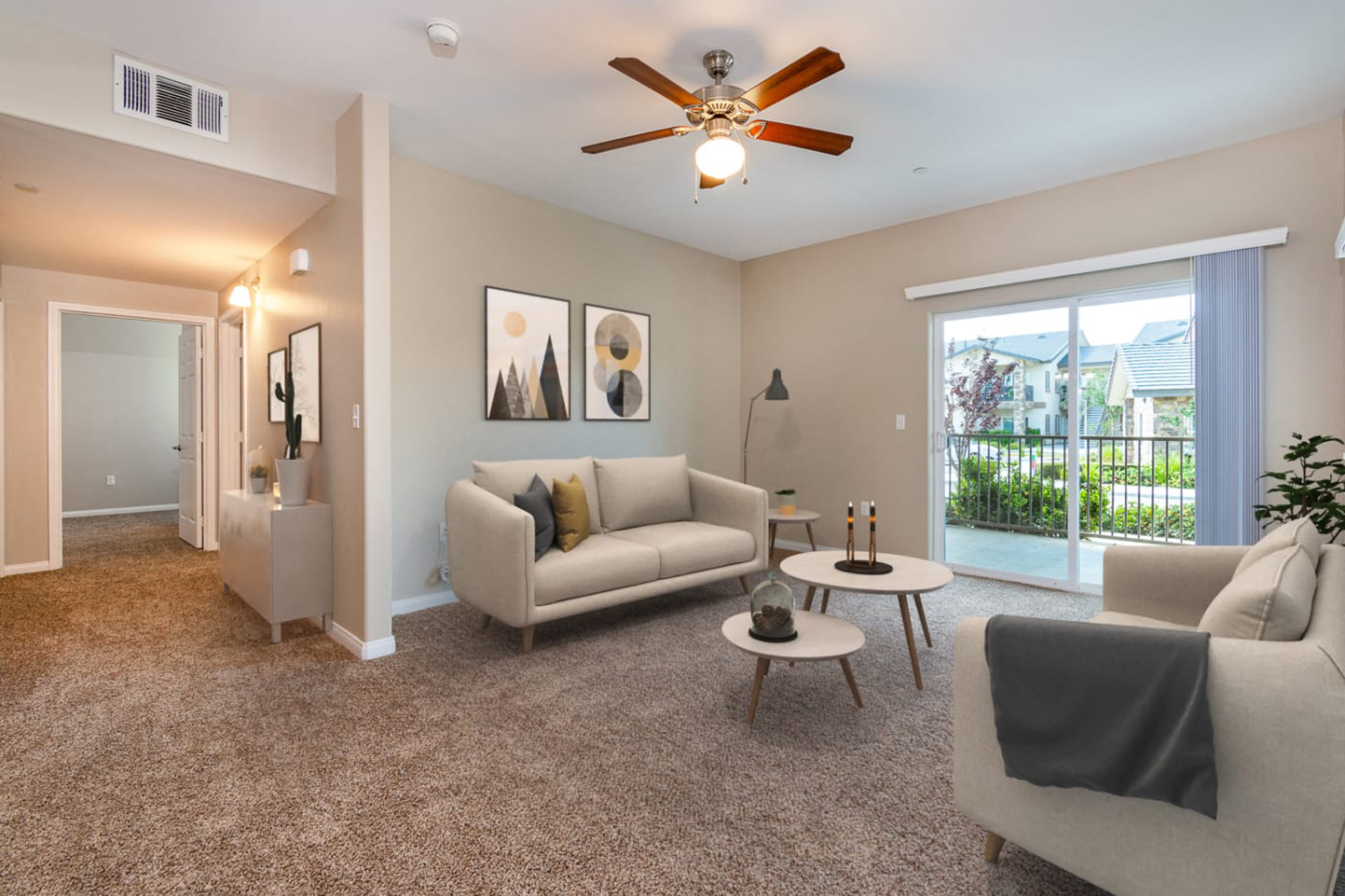 a living room filled with furniture and a large window