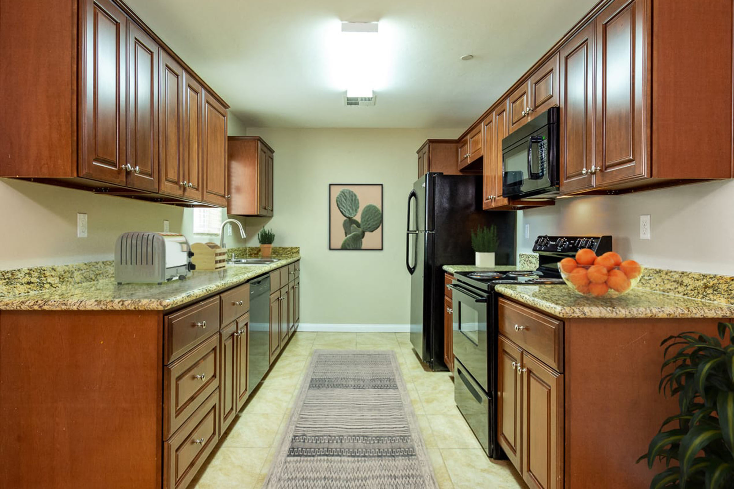 a large kitchen with stainless steel appliances and wooden cabinets