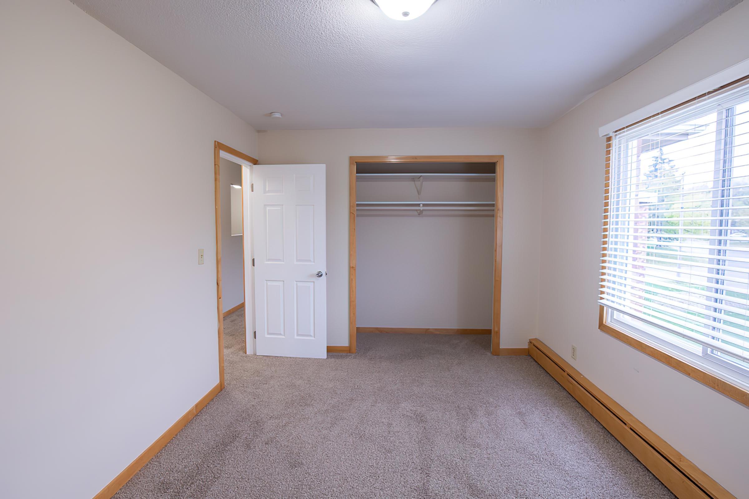 a bedroom with a large window