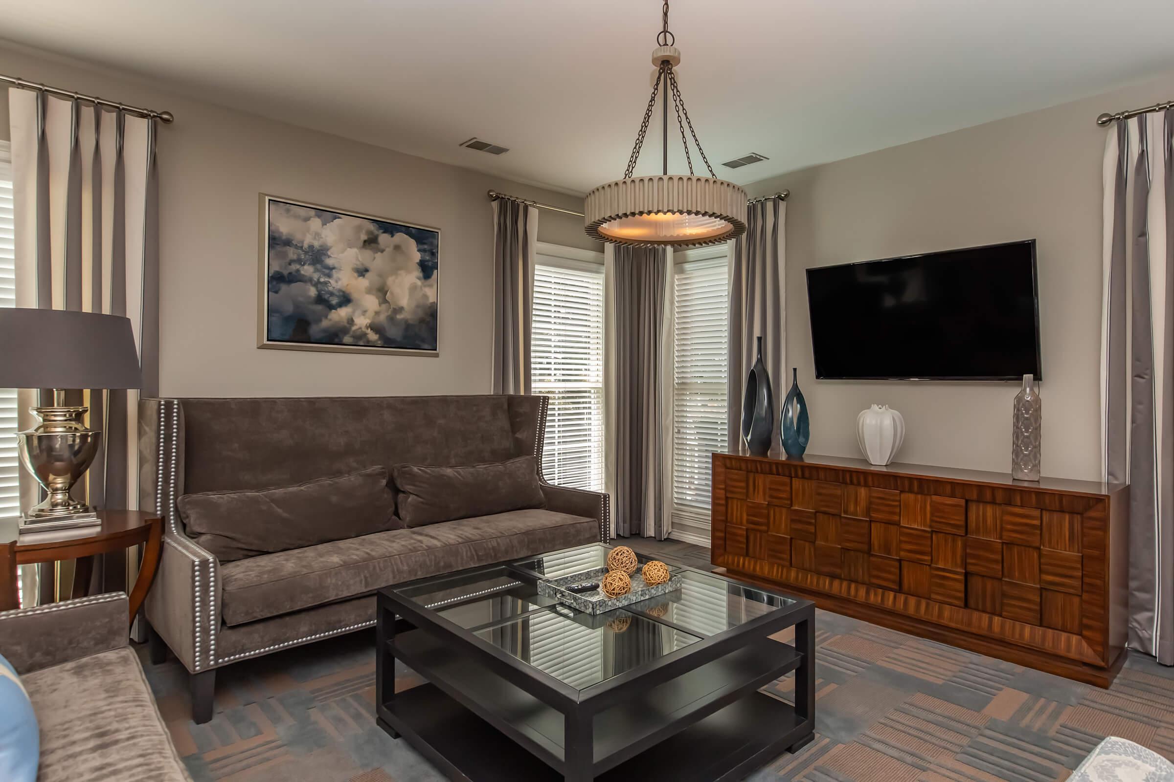 a living room filled with furniture and a flat screen tv