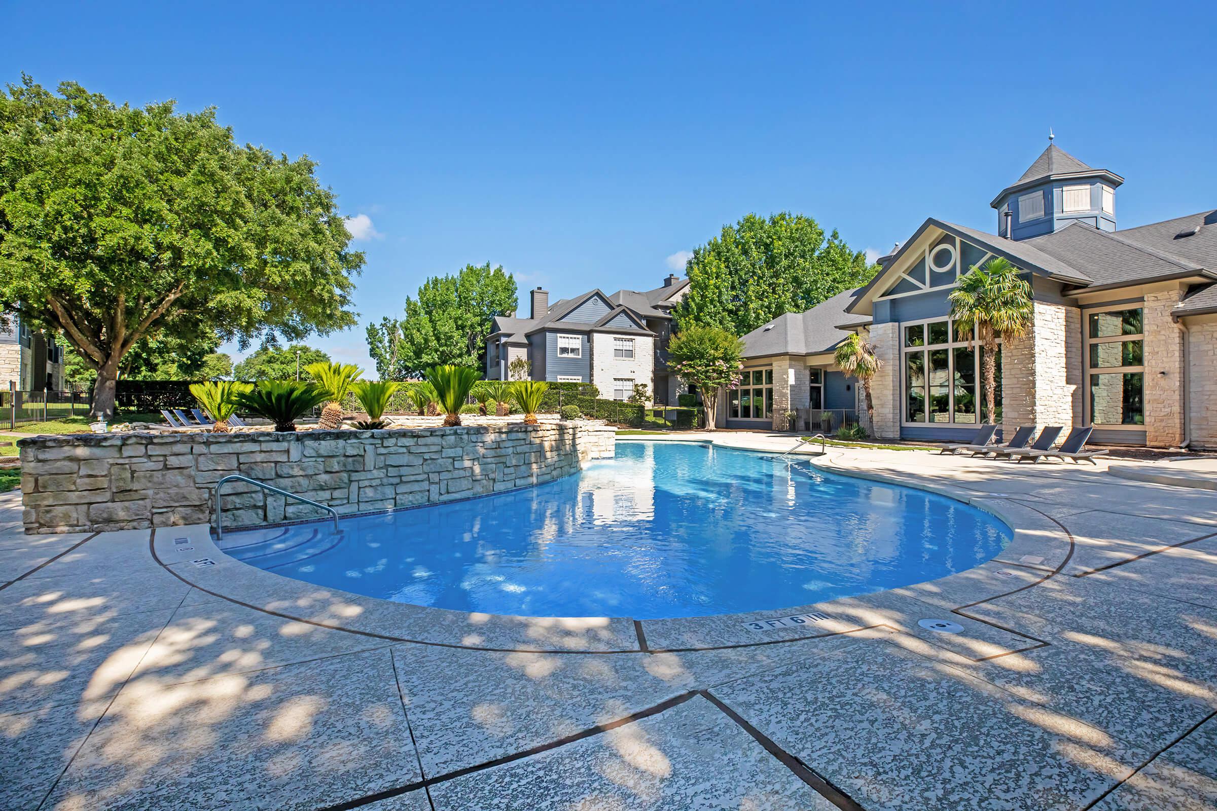 a house with a pool in front of a building