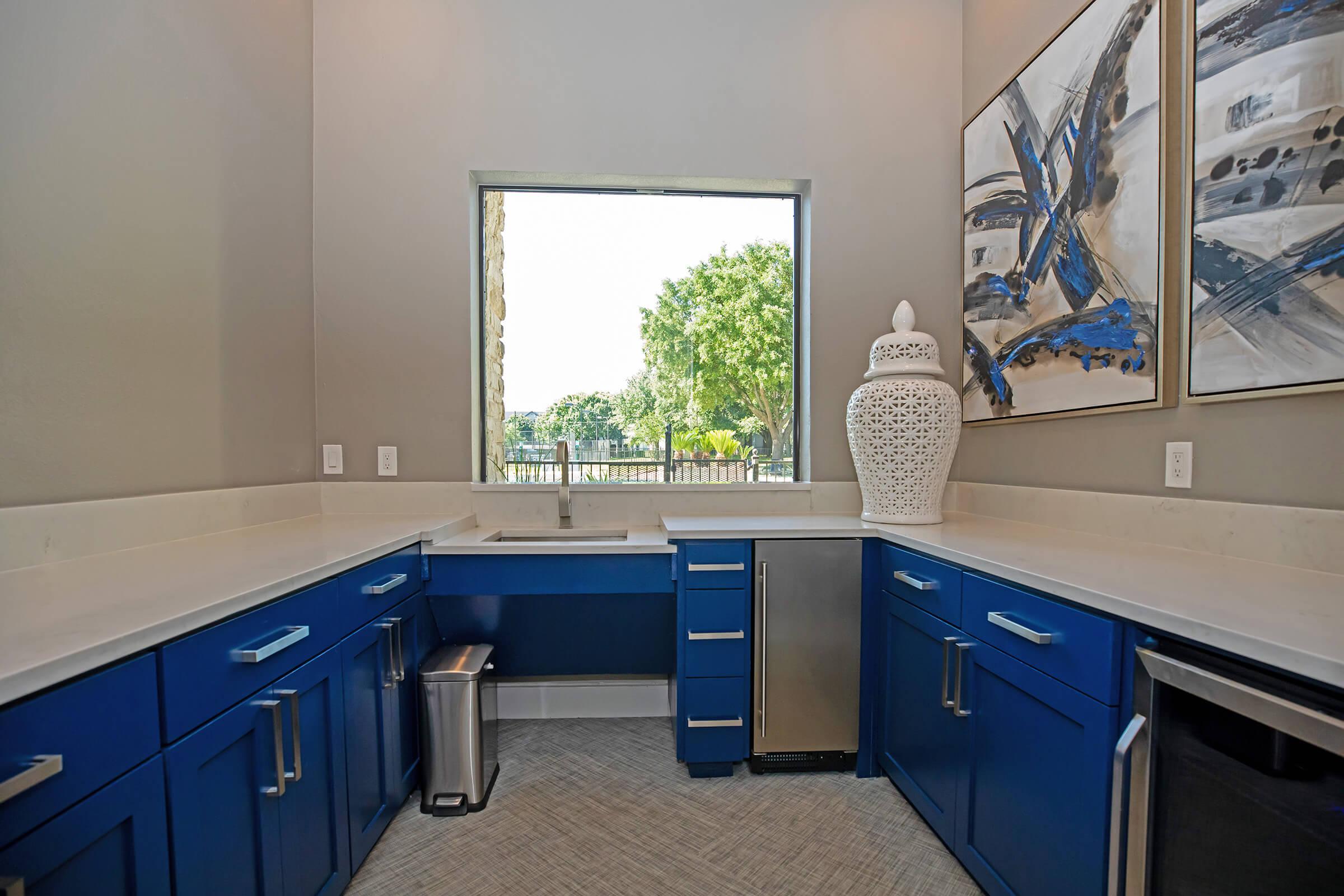 a kitchen with a blue background