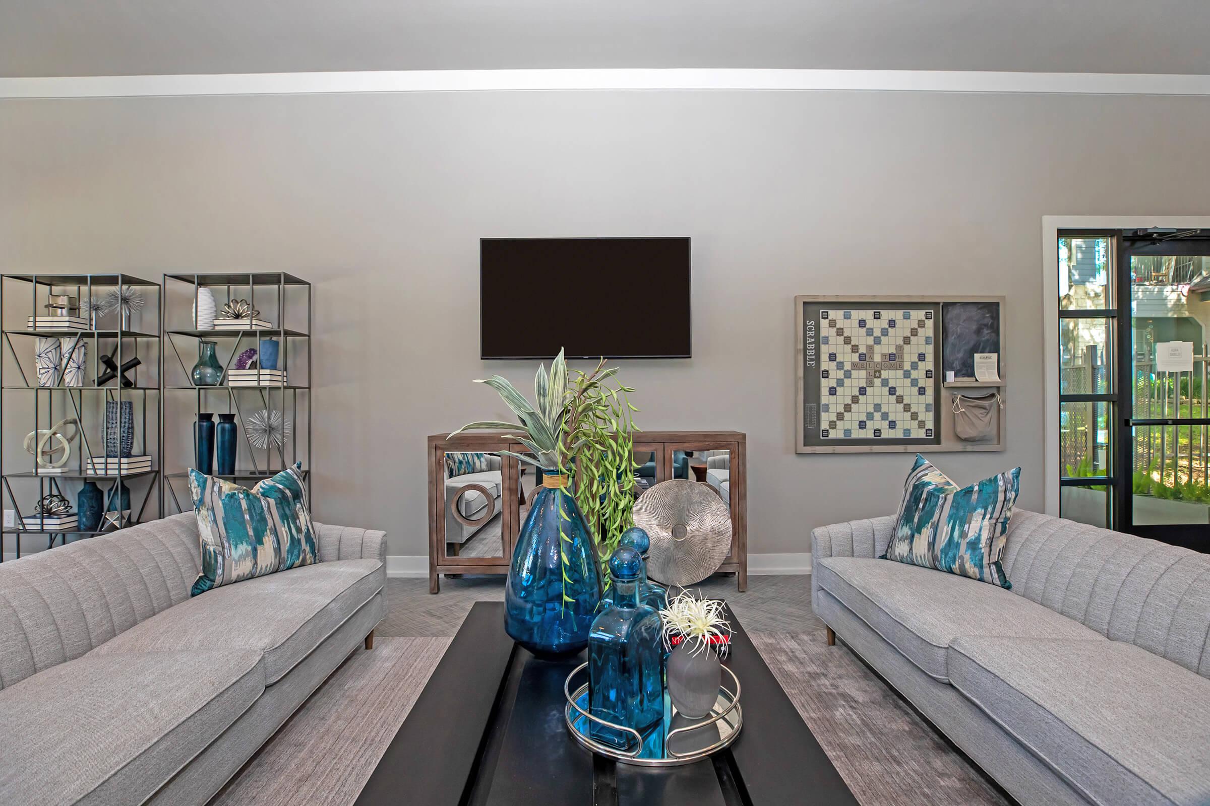 a living room filled with furniture and a tv