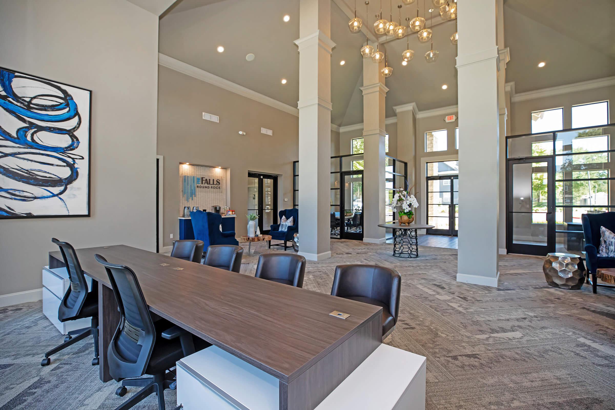 The Falls Round Rock Apartments community room with two desks