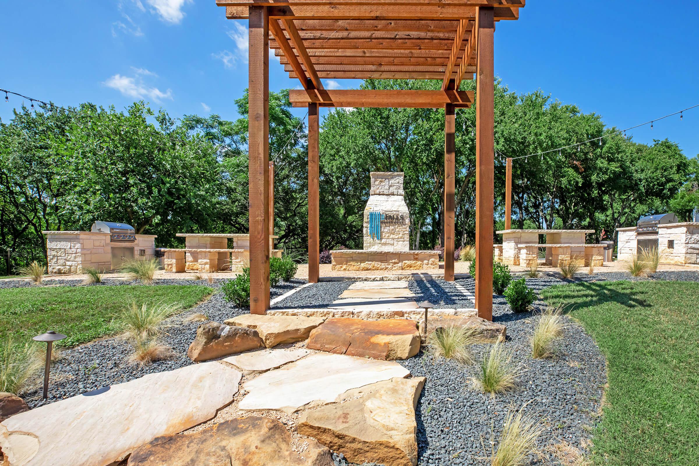 walkway to community courtyard with a pergola