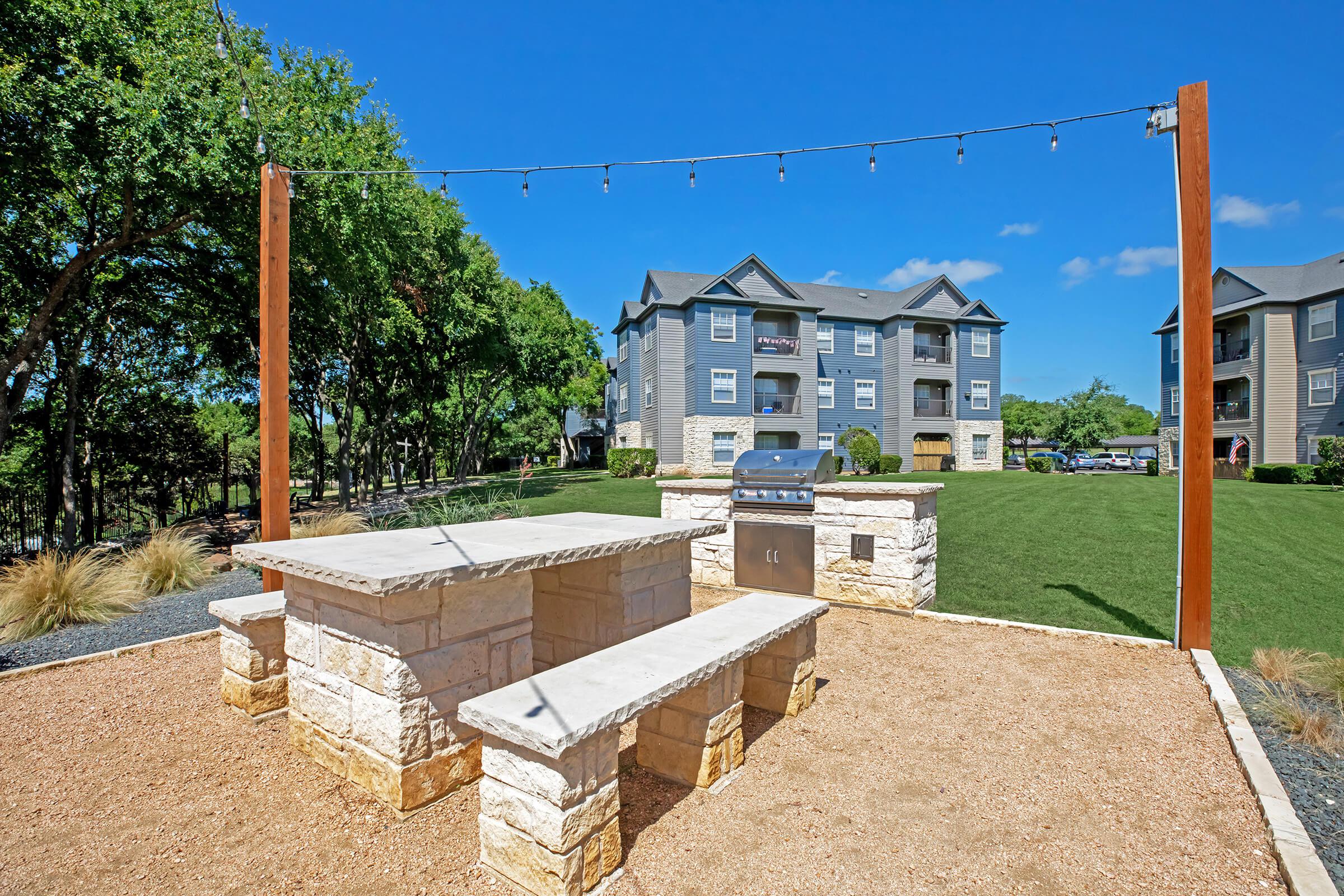 stainless steel barbecue next to a picnic table