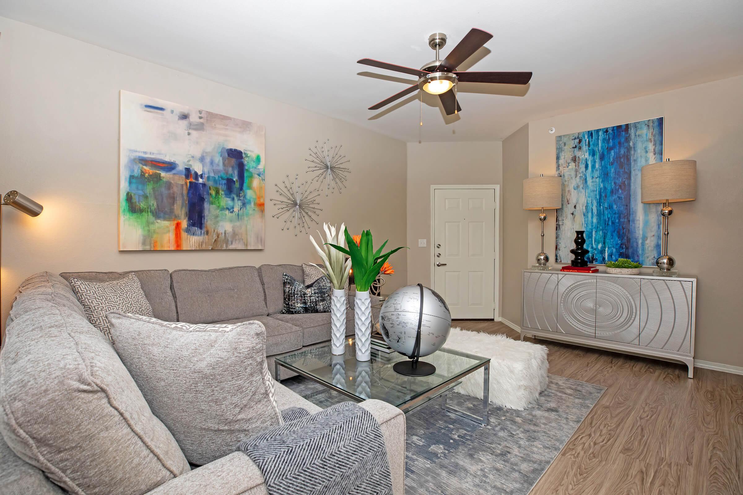 a living room with tan couches