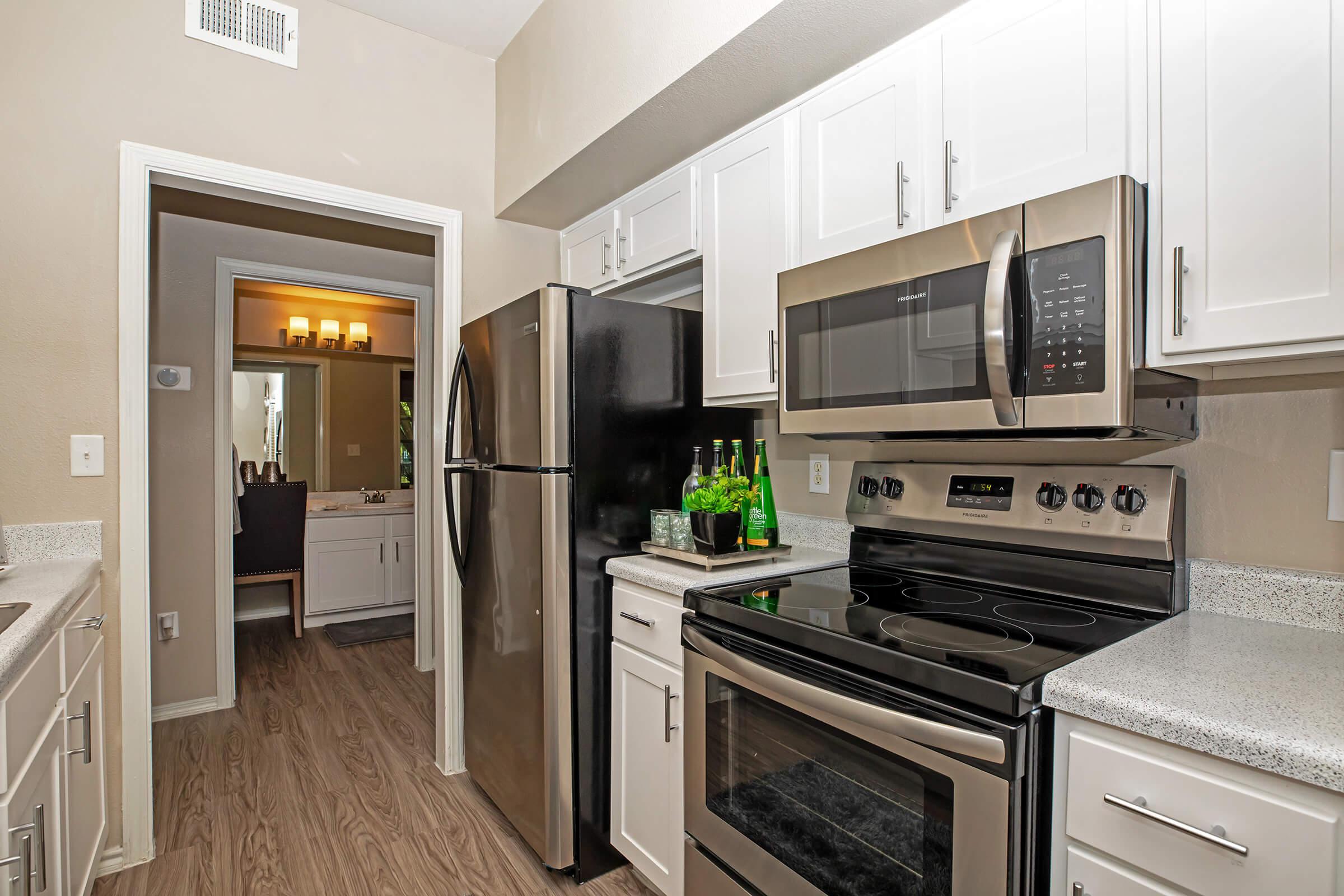 a kitchen with white cabinets