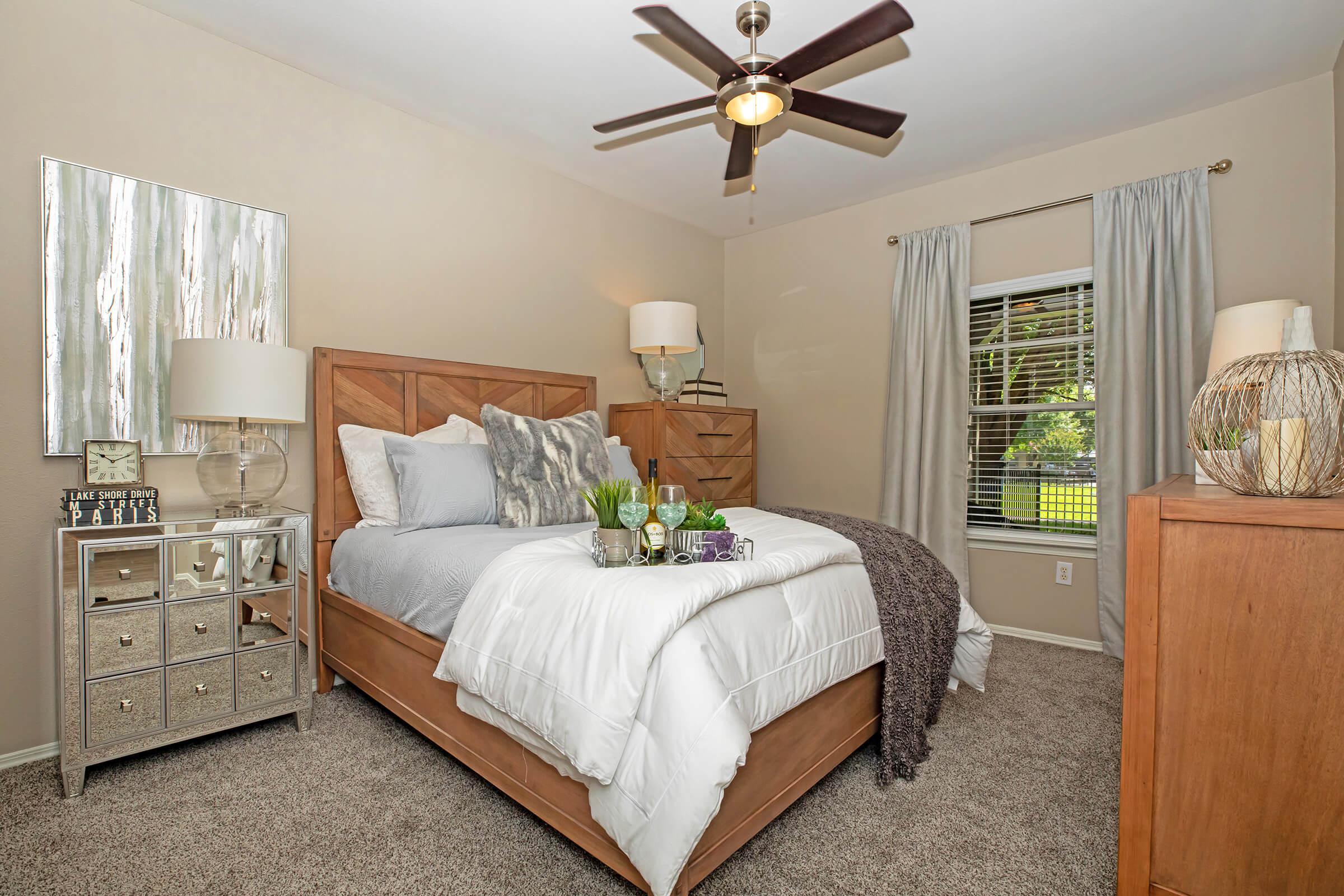 a bedroom with a white comforter