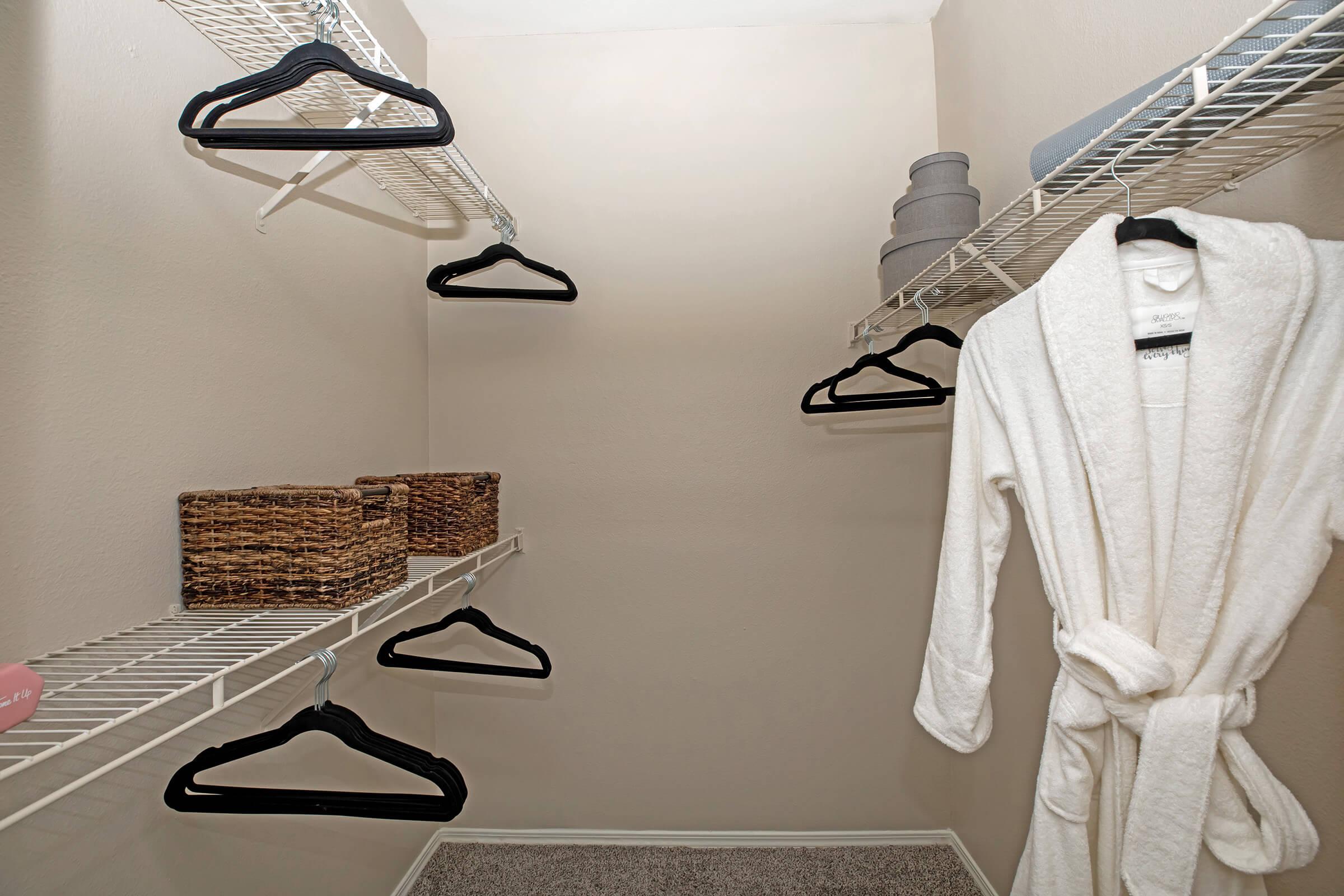 a walk-in closet with hangers
