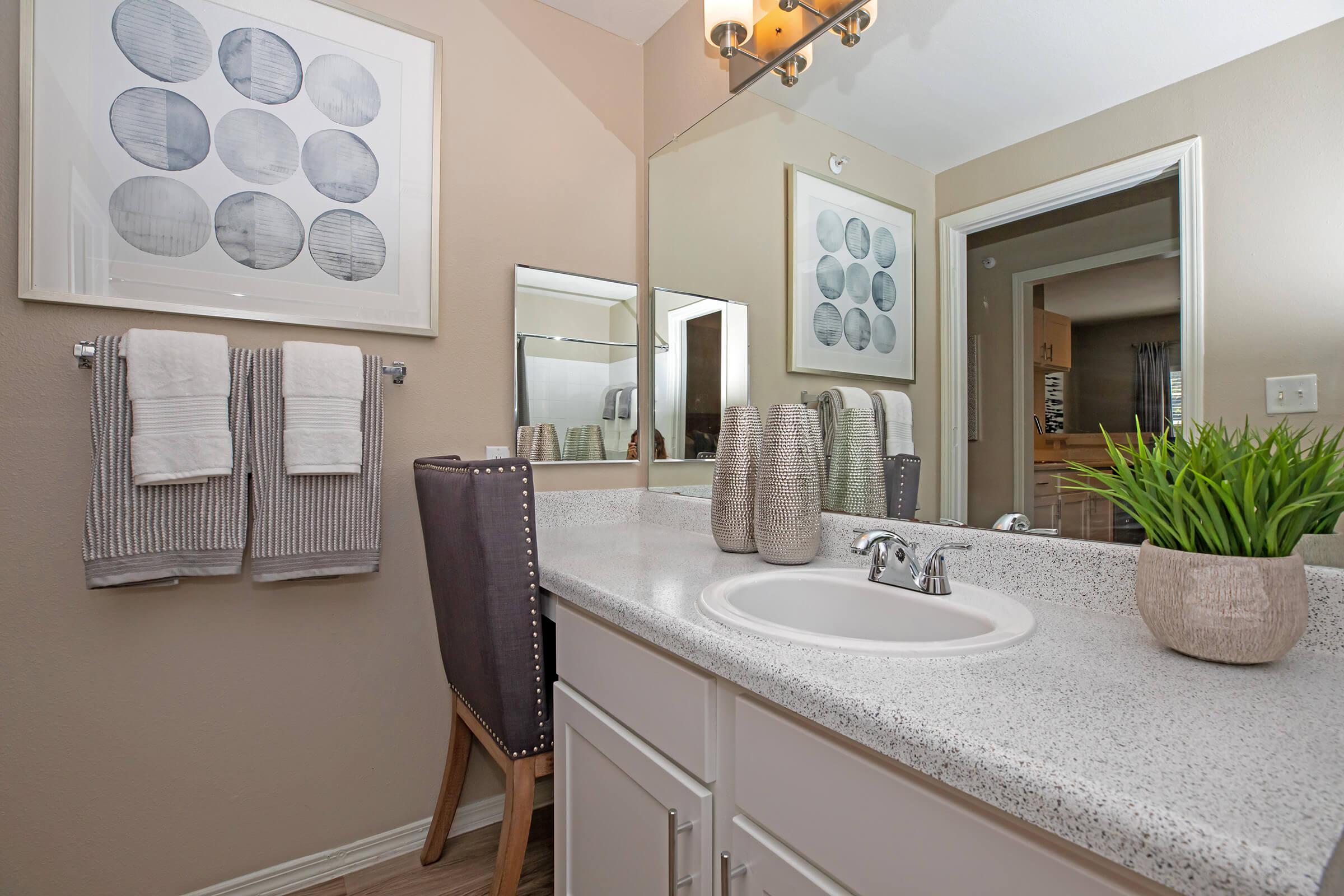 a bathroom with white cabinets