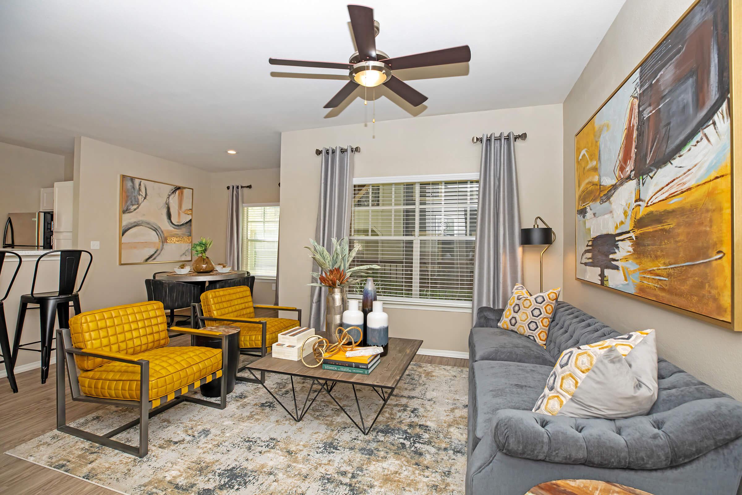 a furnished living room with an gray couch