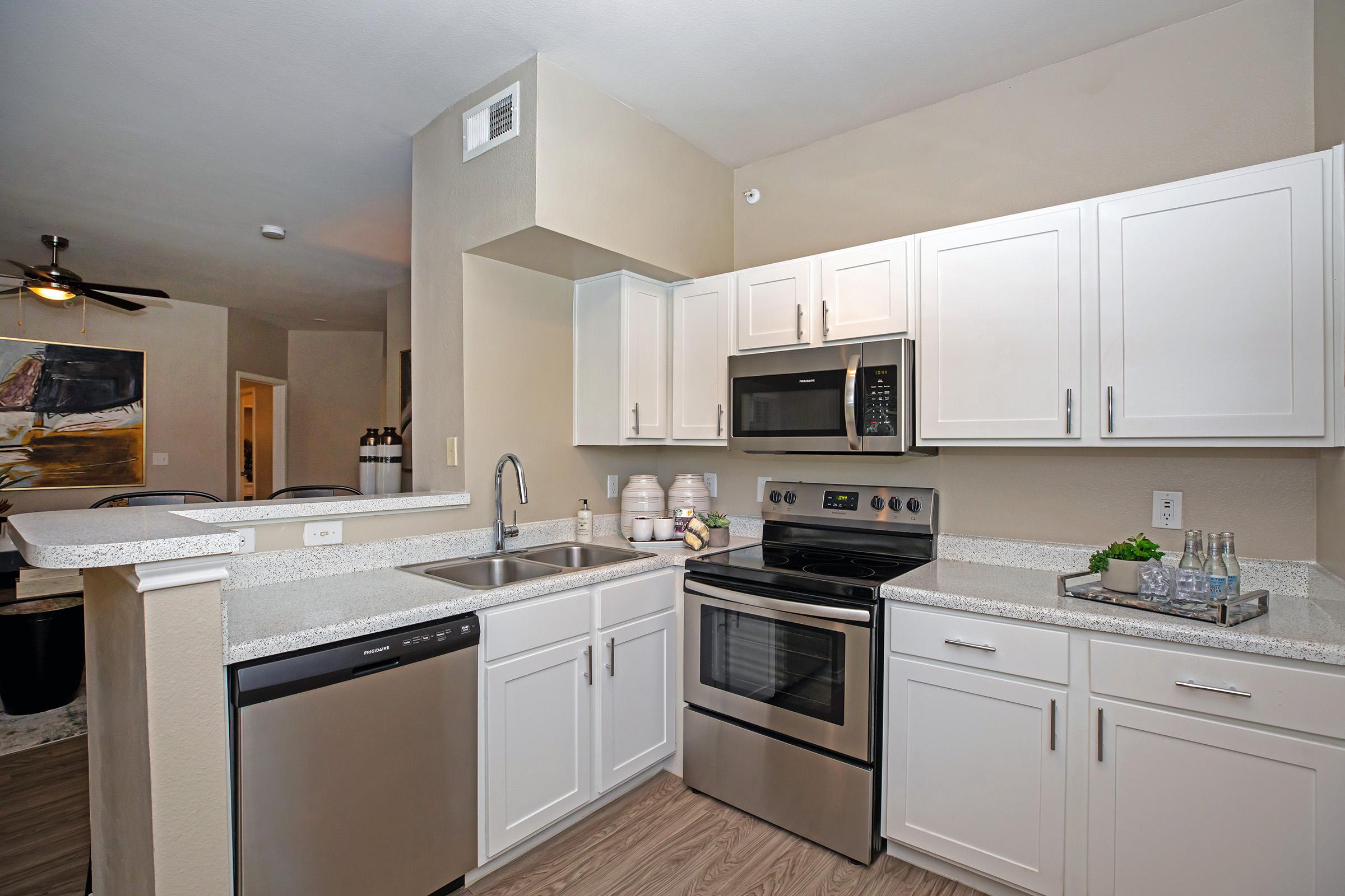 a furnished kitchen with stainless steel appliances