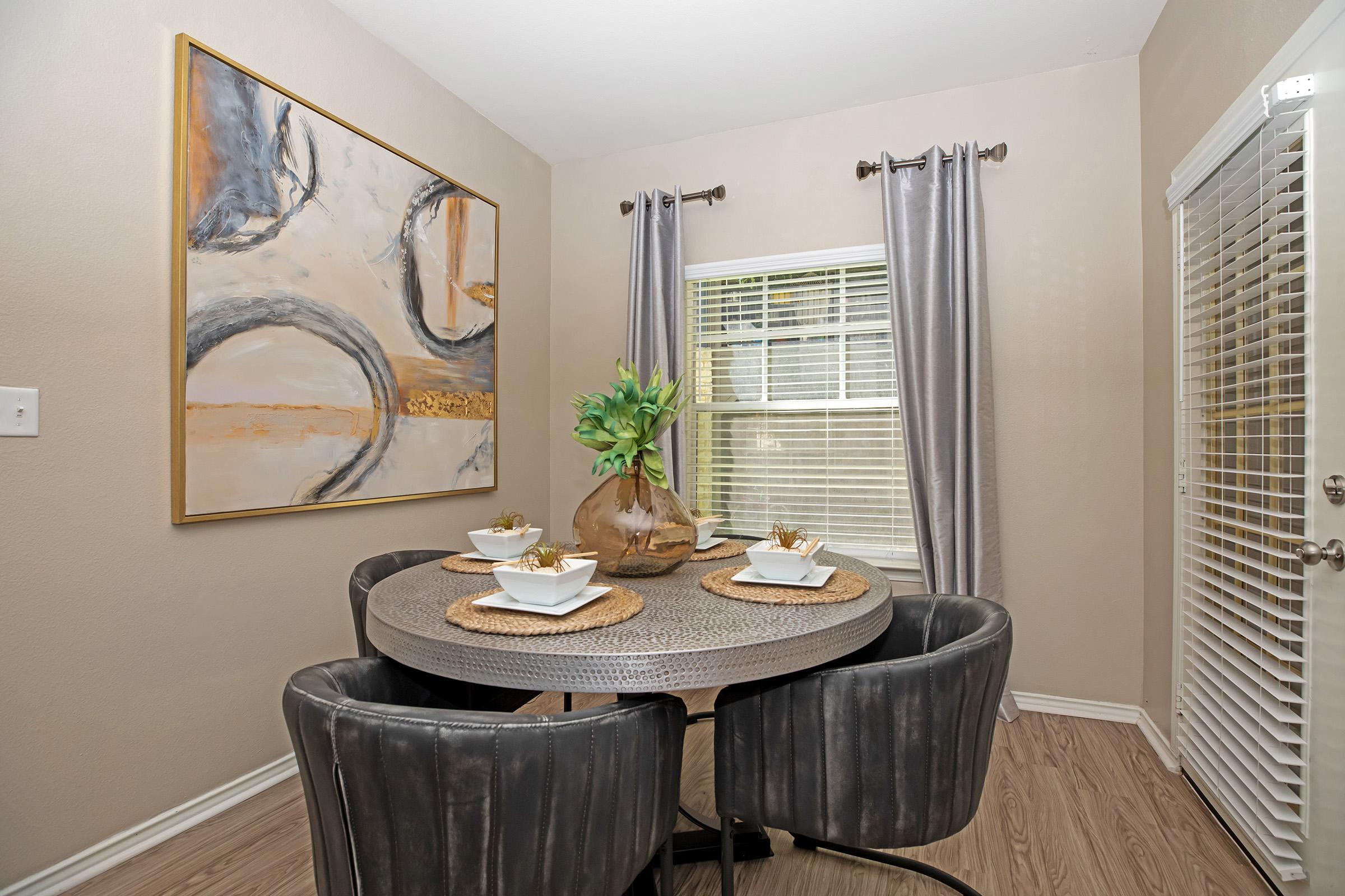 a furnished dining room with wooden floors