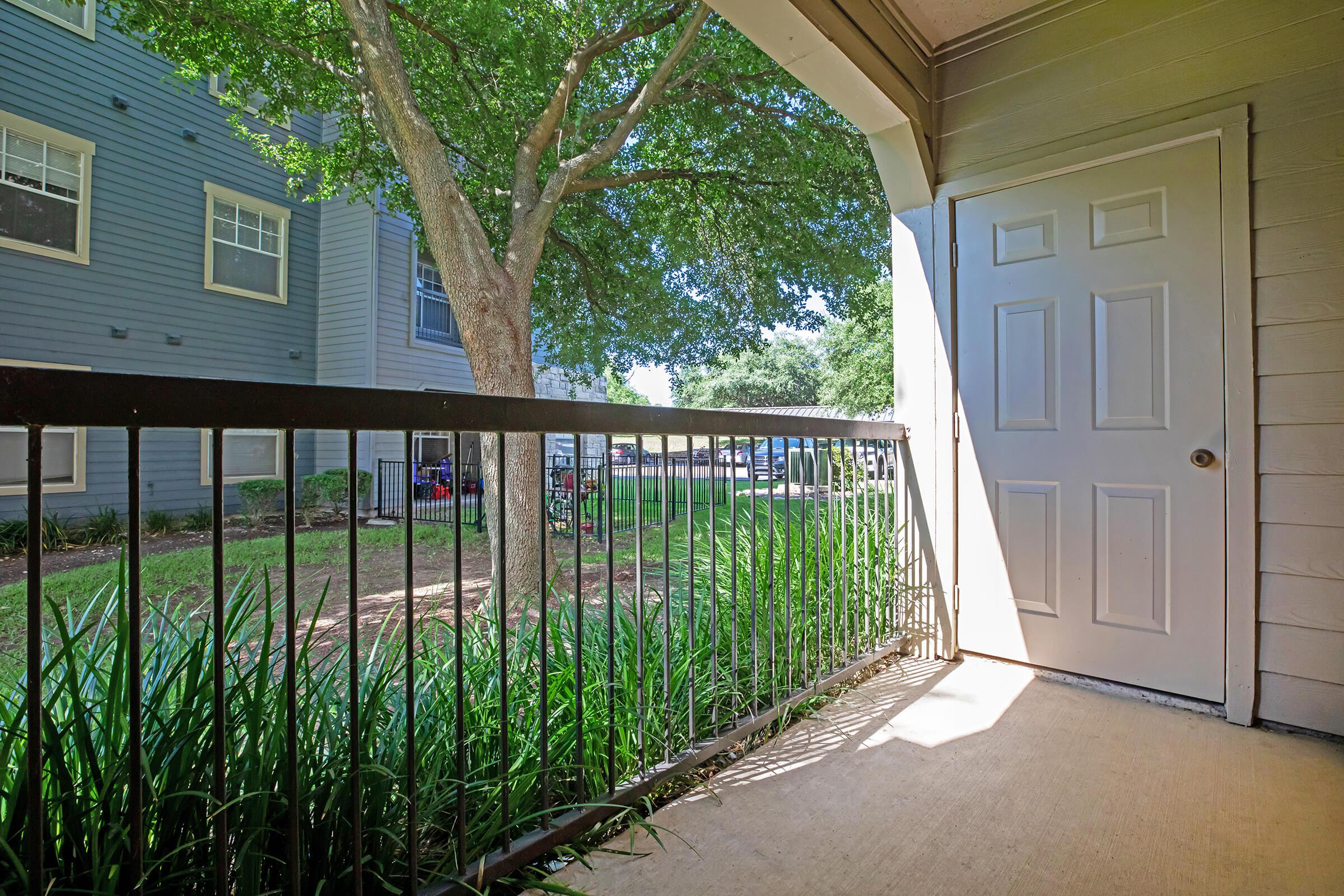 a house with a fence in front of a building