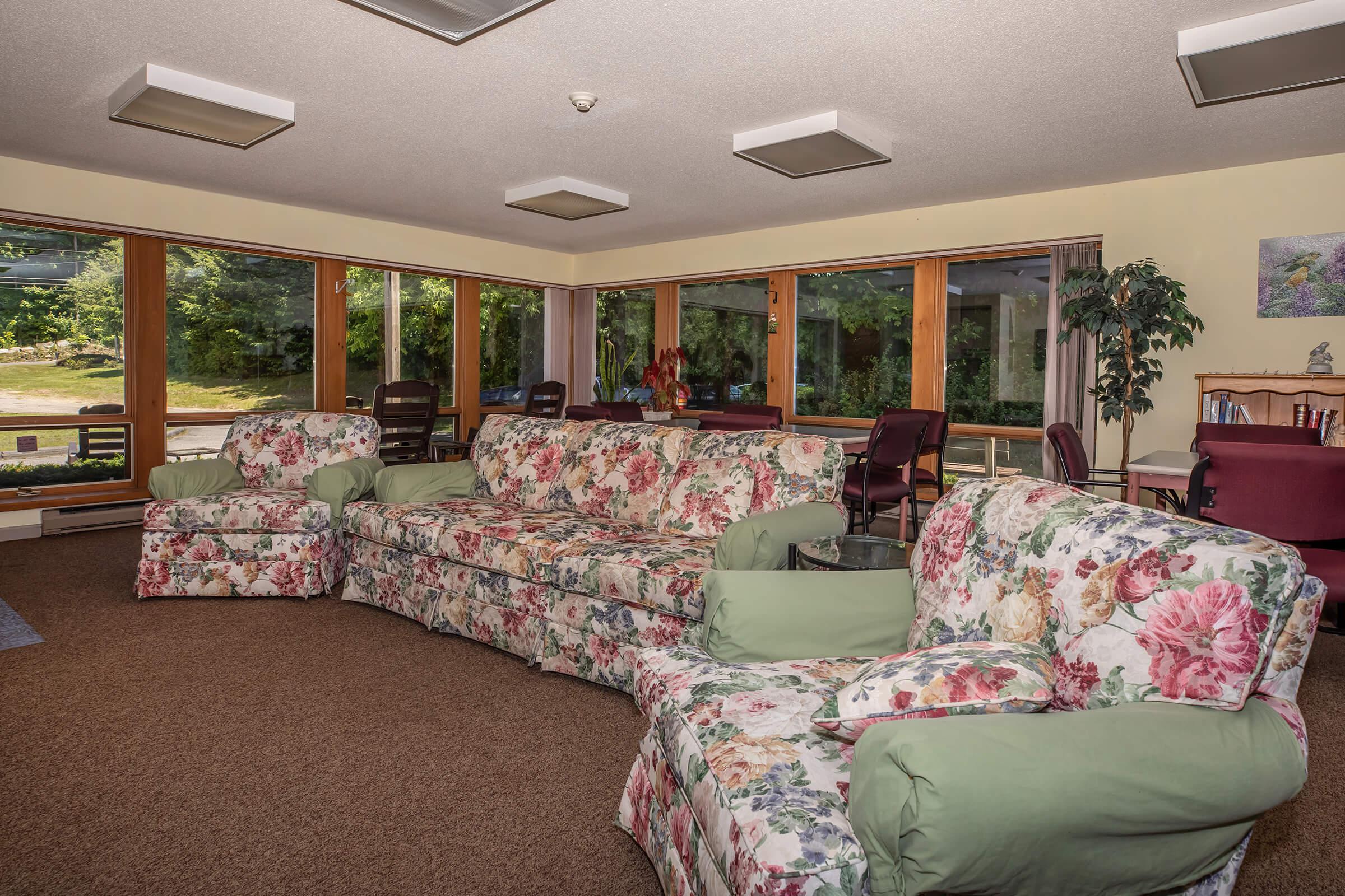 a living room filled with furniture and a large window