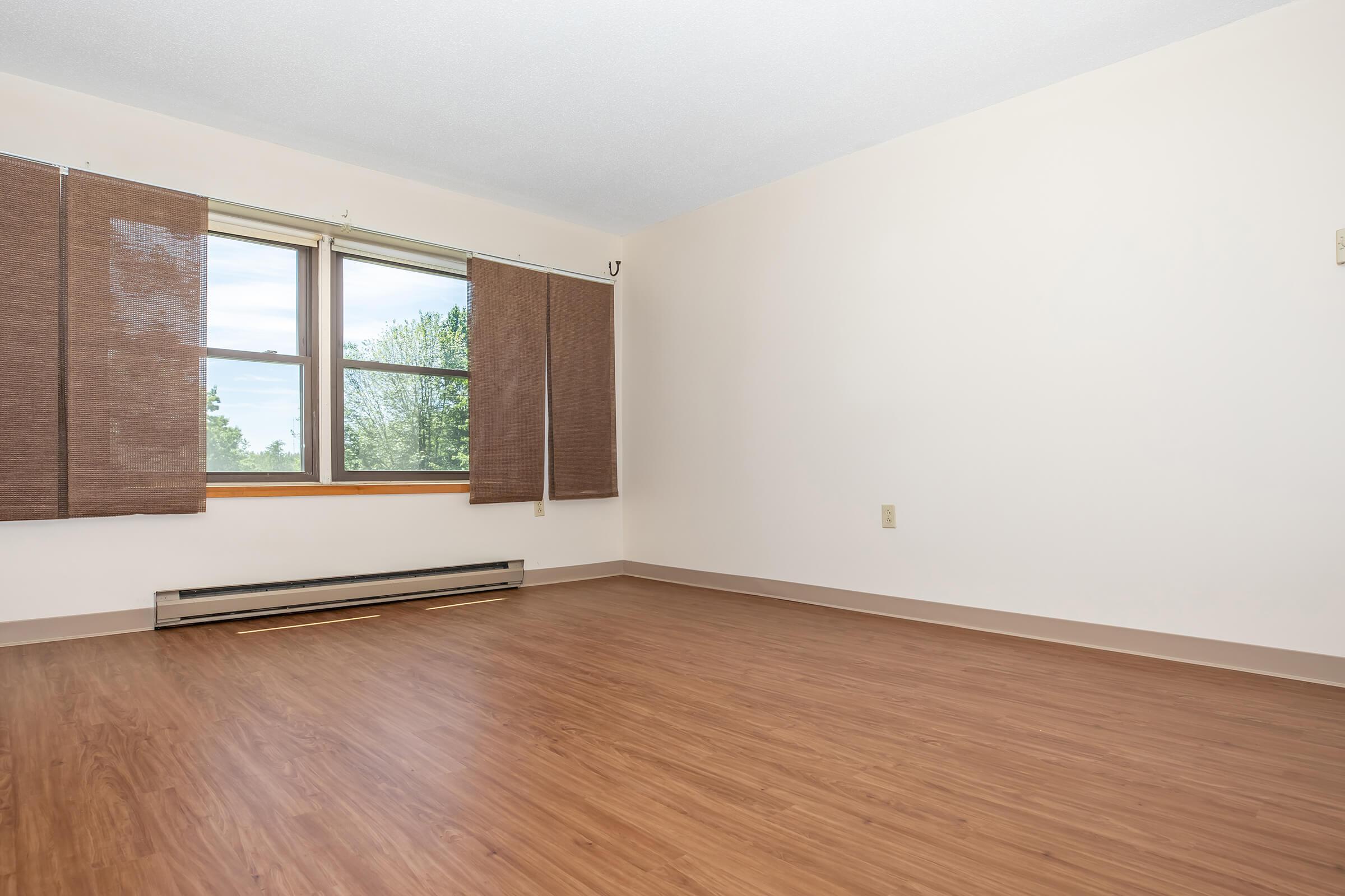 a large empty room with a wooden floor