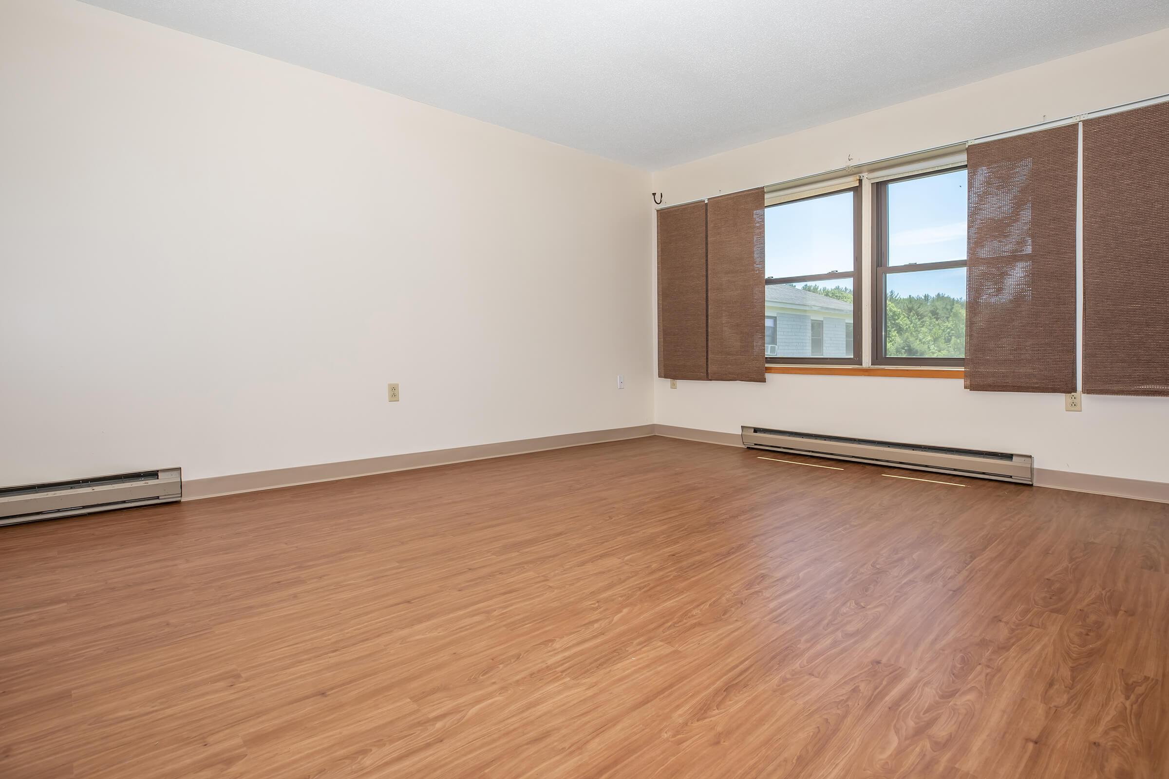 a large empty room with a wooden floor