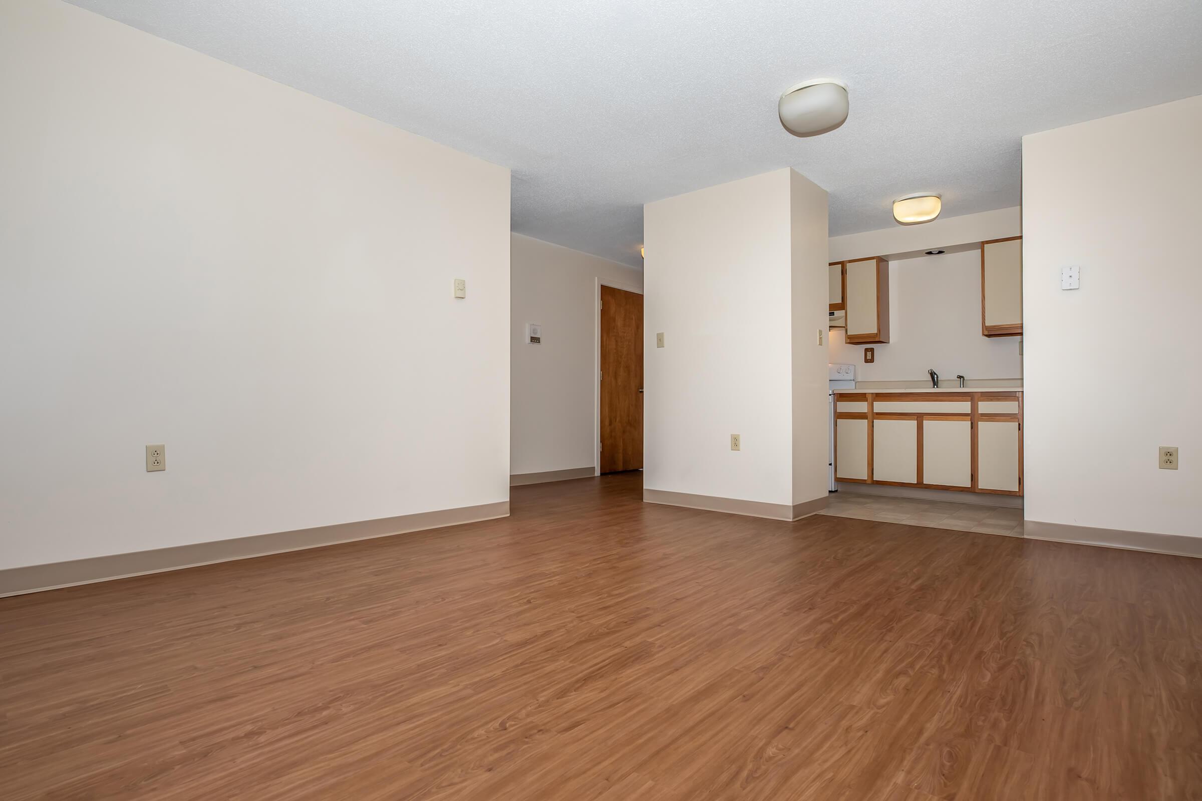 a large empty room with a wood floor