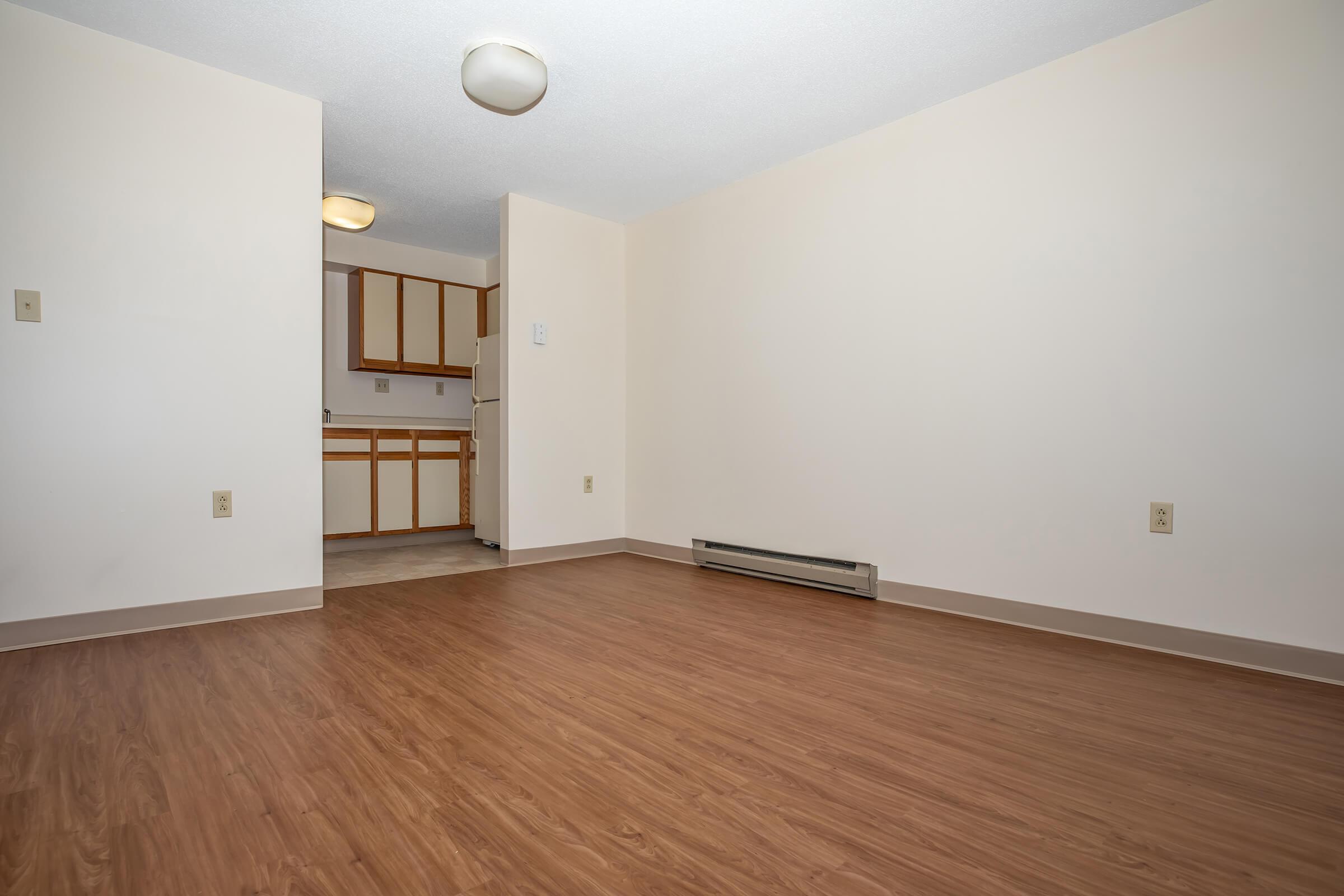 a large empty room with a wood floor