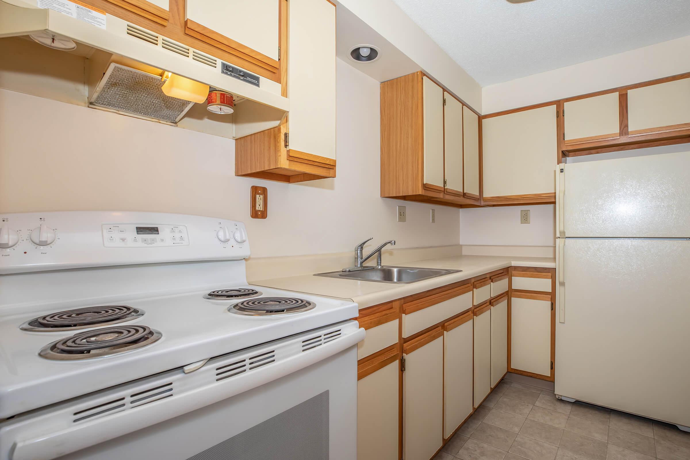 a stove top oven sitting inside of a kitchen