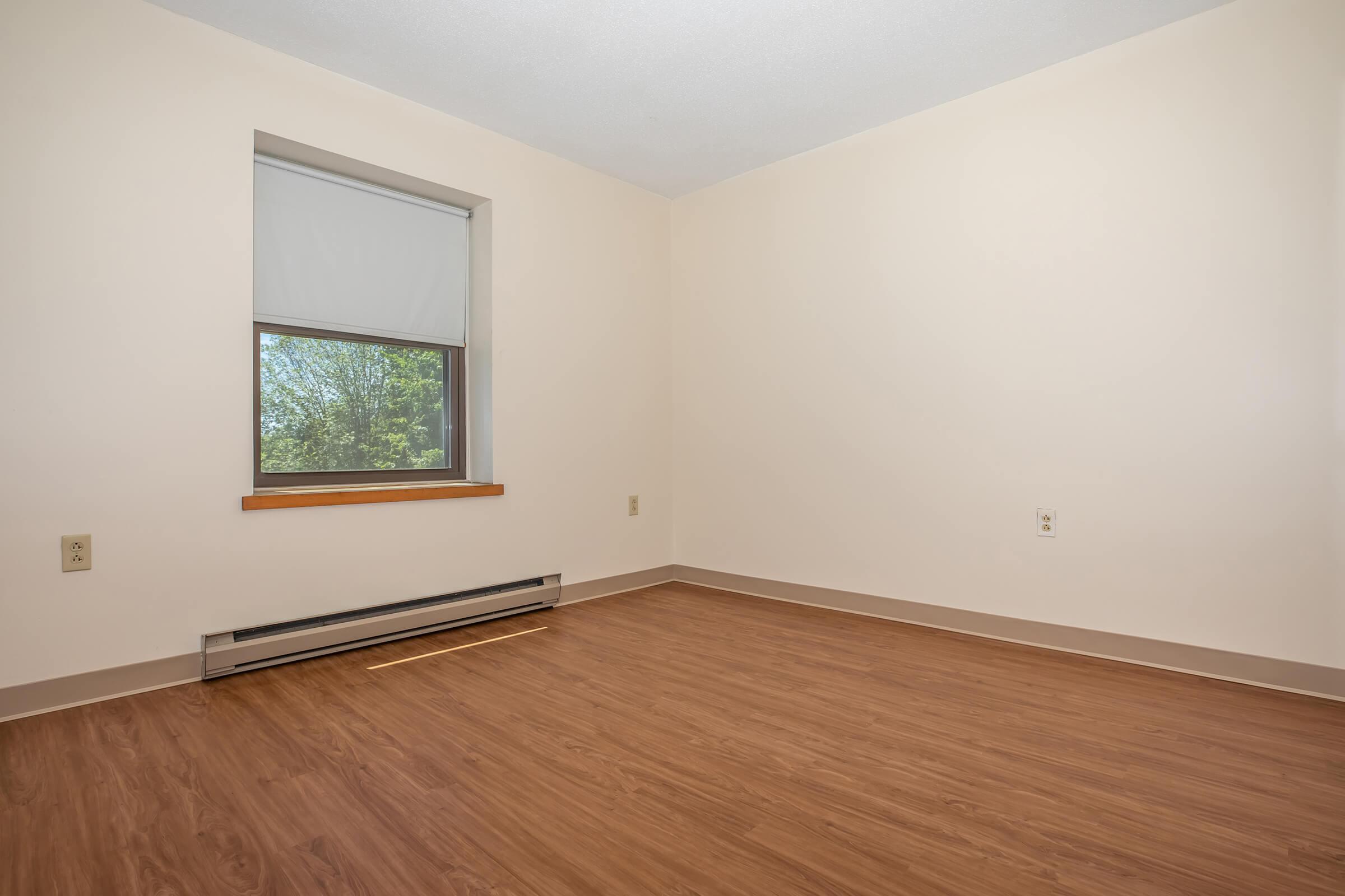 a bedroom with a wooden floor