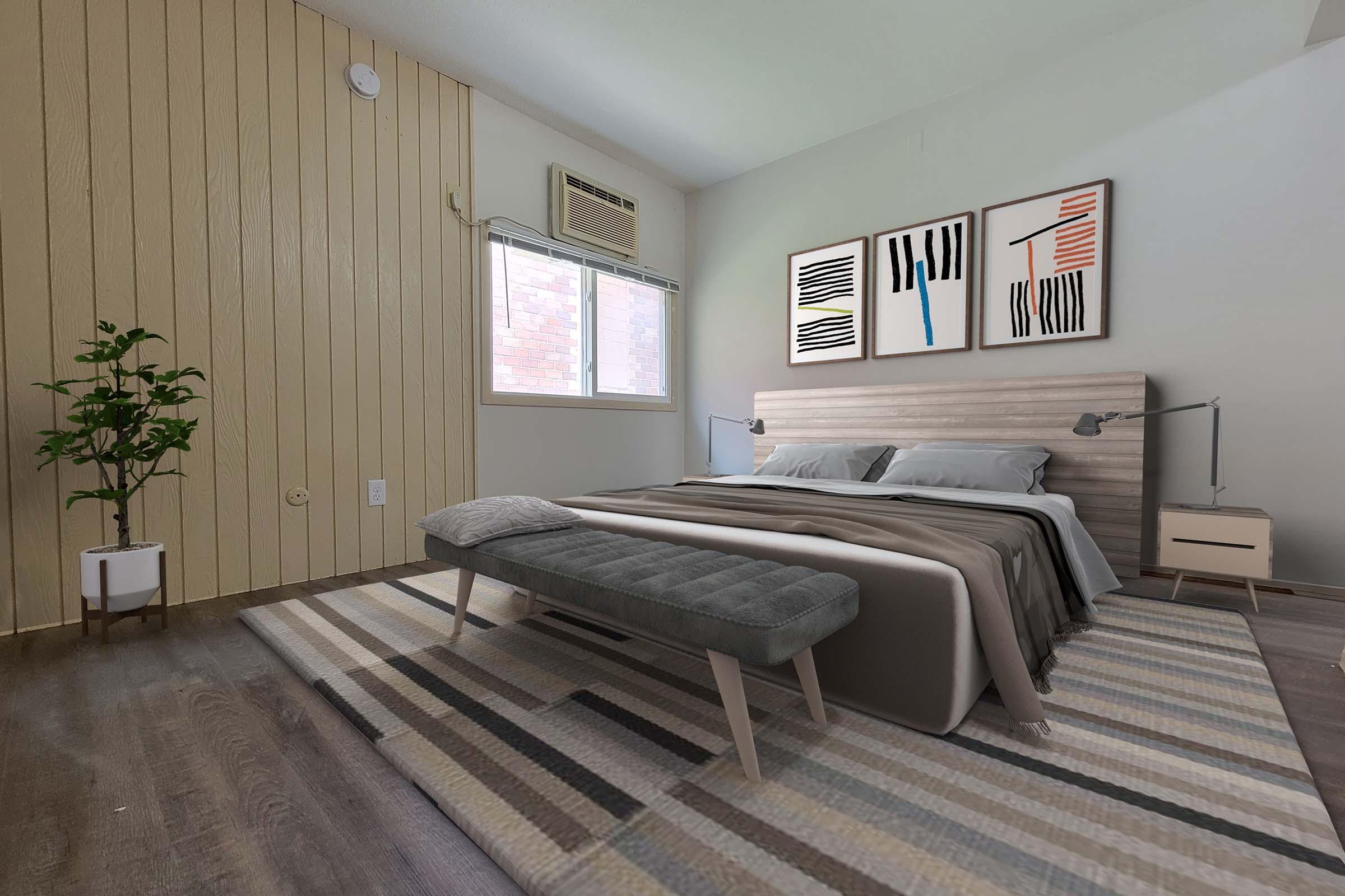 A modern bedroom featuring a bed with gray bedding and two bedside lamps. A minimalist bench is at the foot of the bed. The room includes a plant in a pot, a large window with light curtains, and abstract wall art. Light wooden paneling and a rug with geometric patterns enhance the décor.