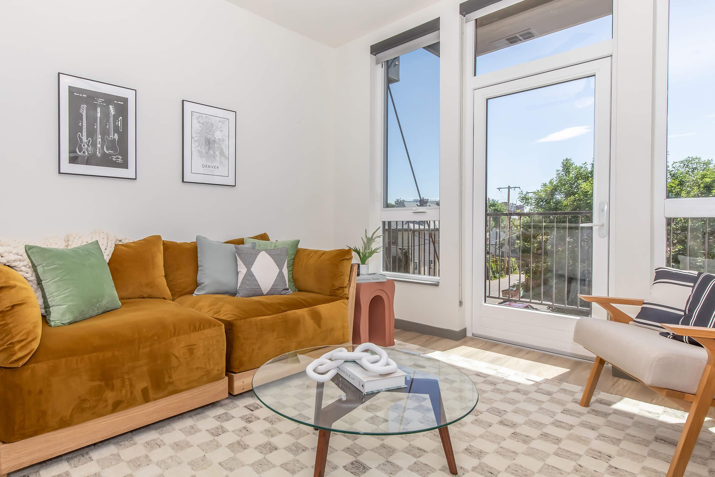 a living room filled with furniture and a large window