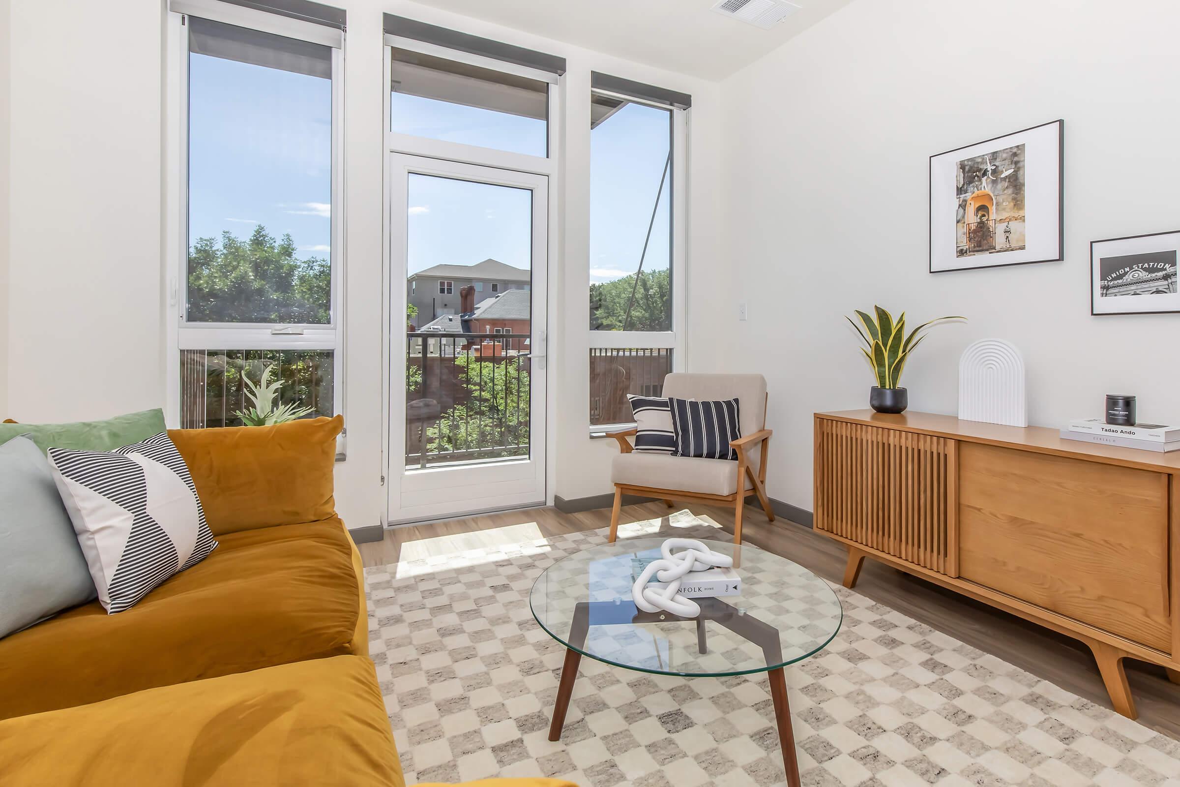 a living room filled with furniture and a large window