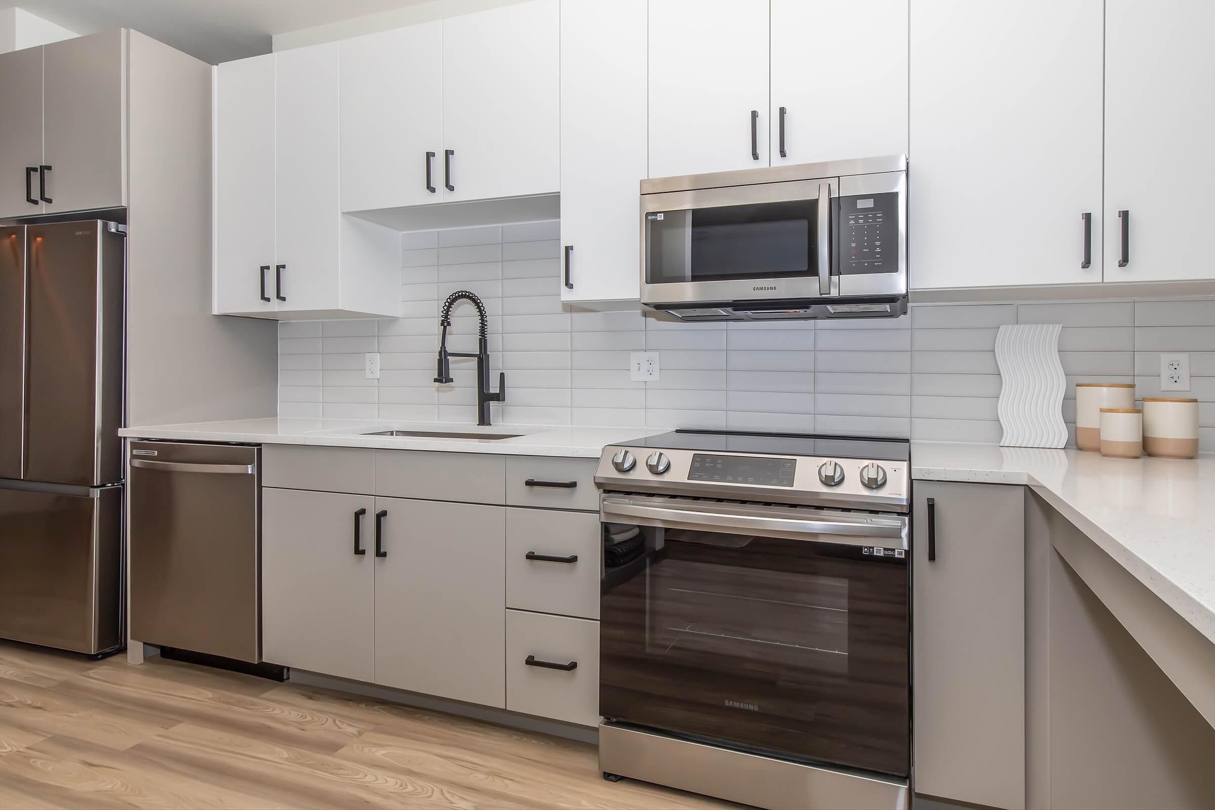 a stove top oven sitting inside of a kitchen