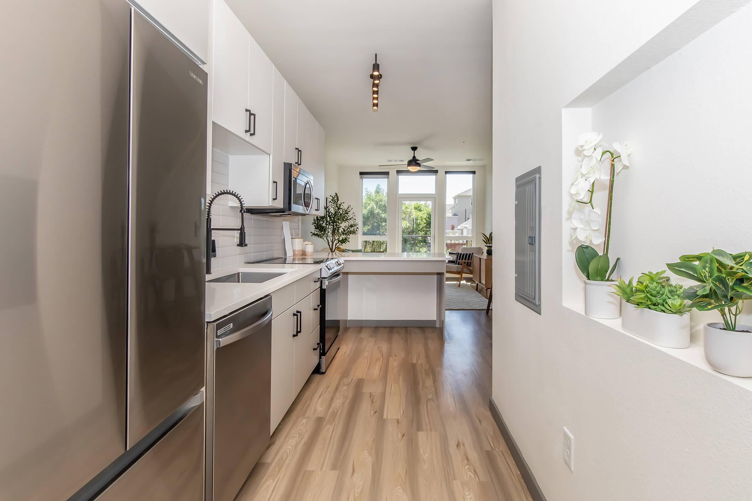 a kitchen with a sink and a mirror