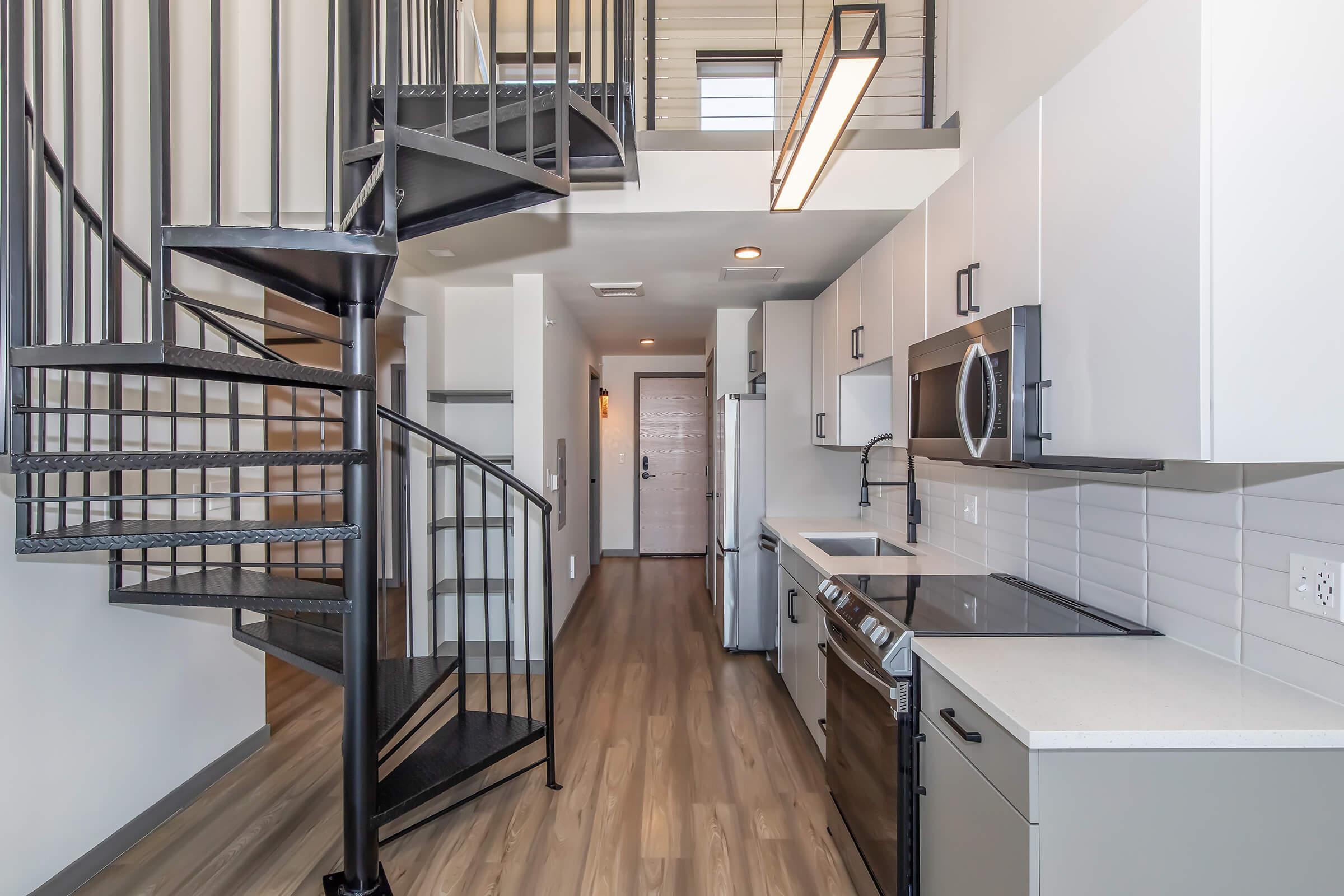 a kitchen area with a building in the background