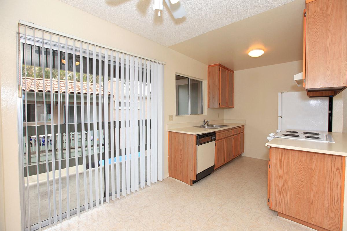 a kitchen with wooden cabinets