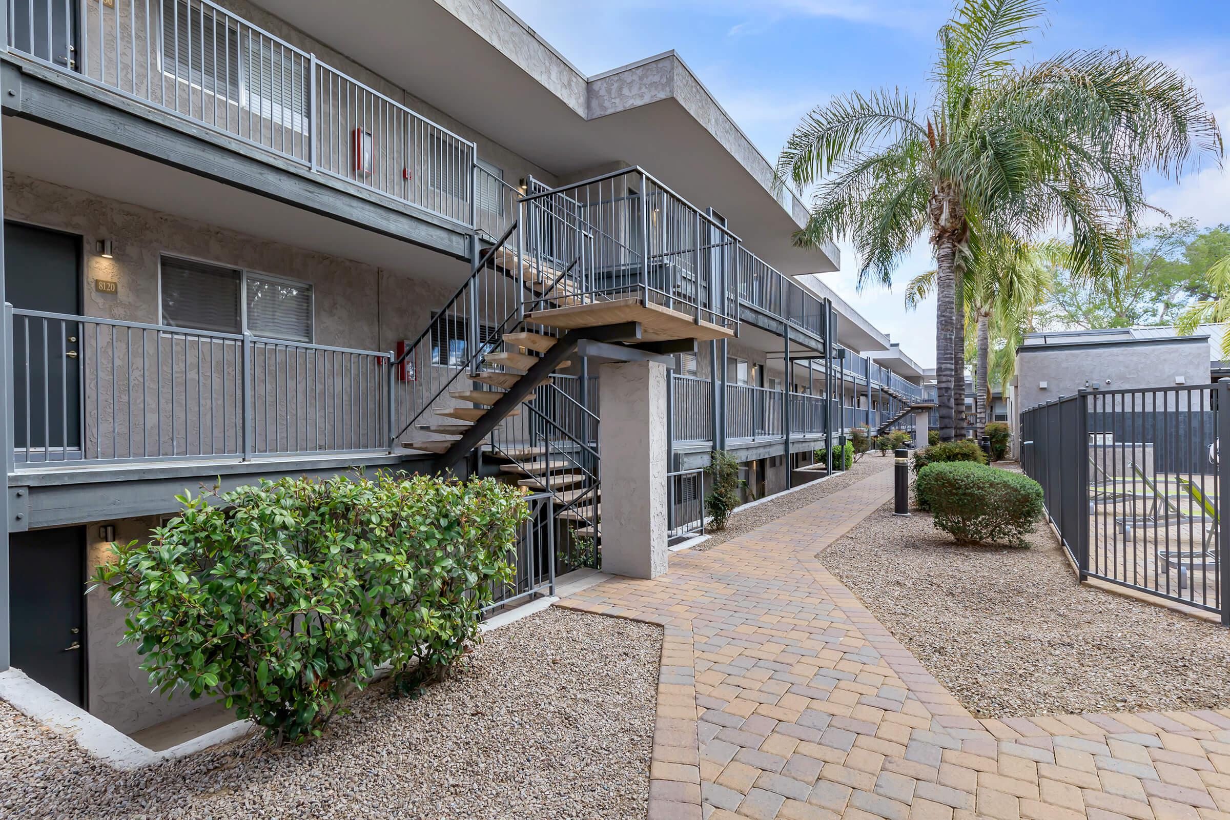 a palm tree in front of a building