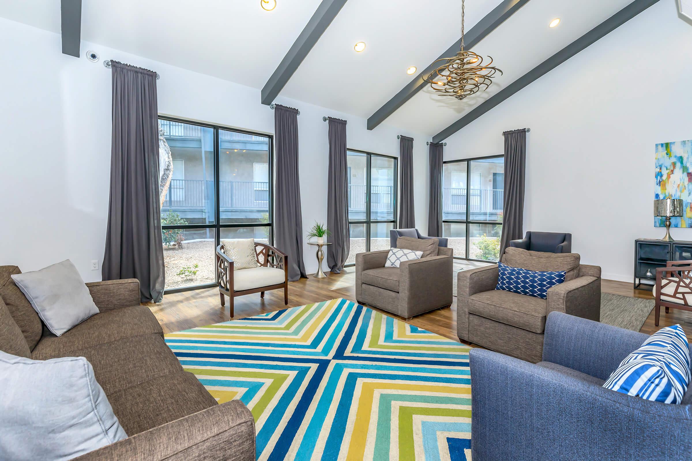 a living room filled with furniture and a large window
