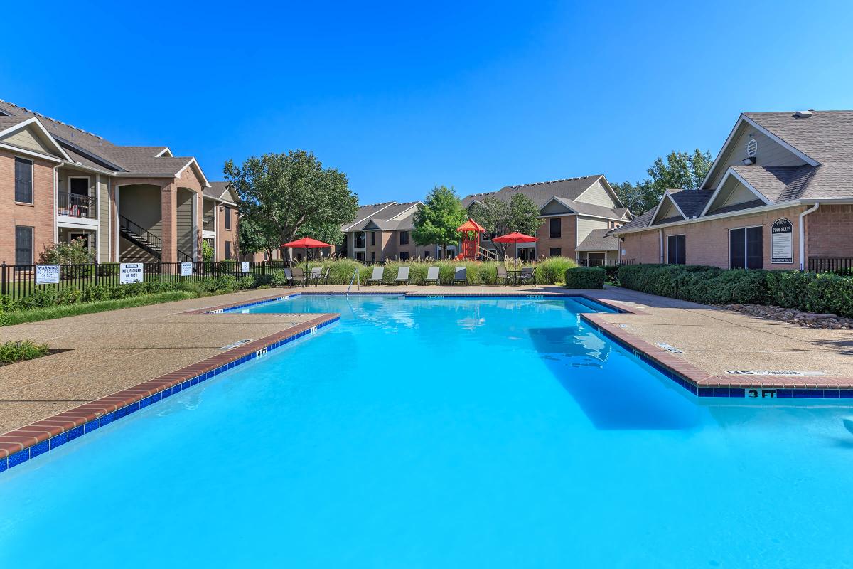 a house with a pool in front of a building