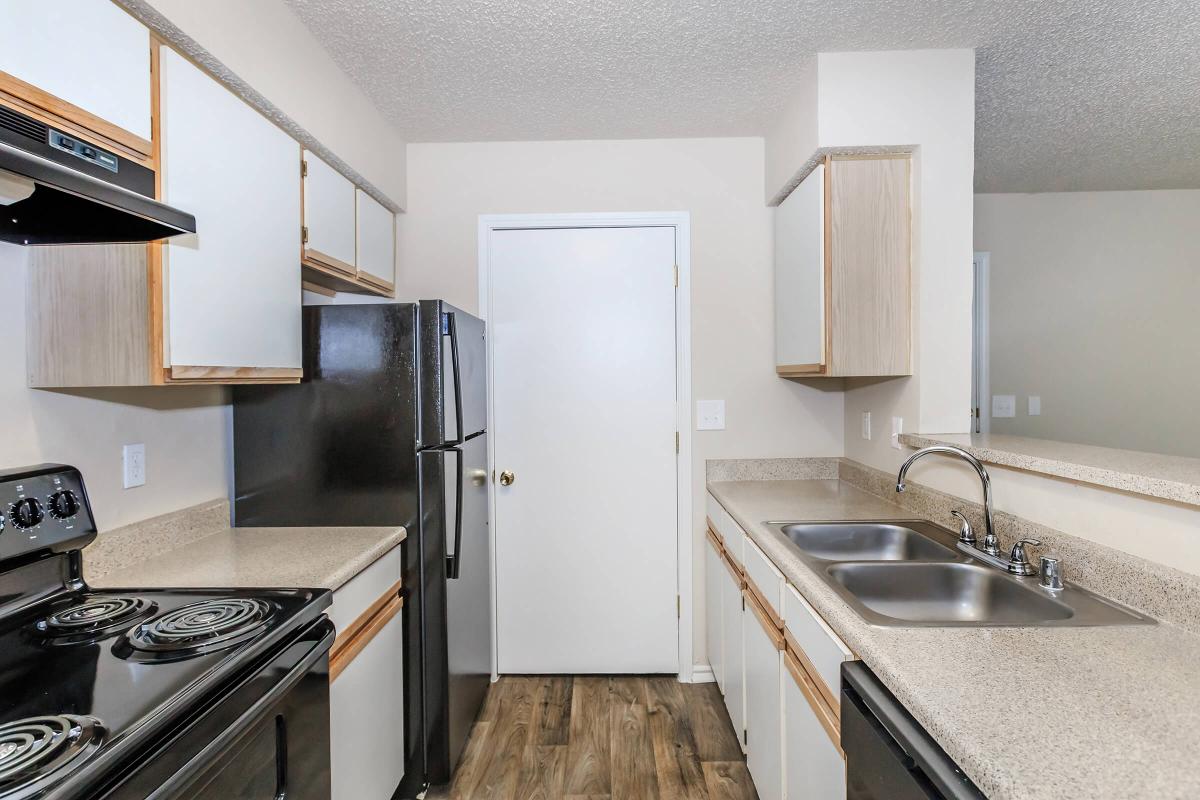 a stove top oven sitting inside of a kitchen