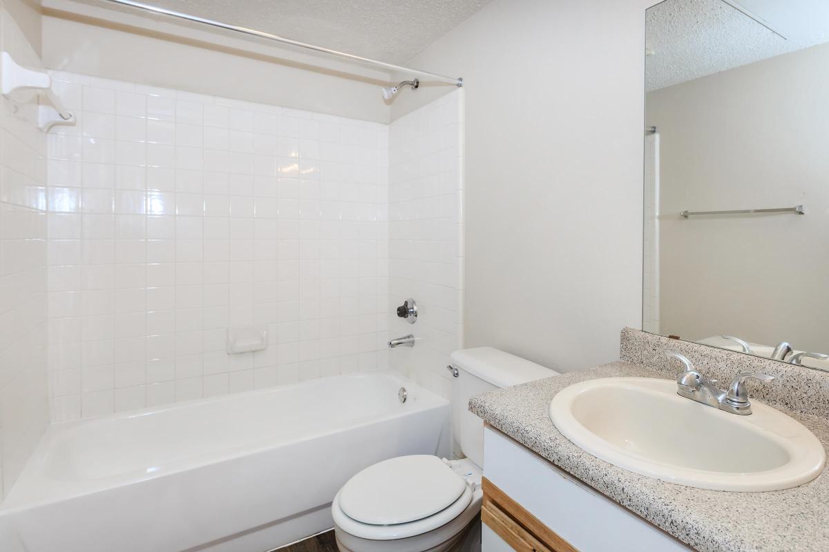 a white tub sitting next to a sink