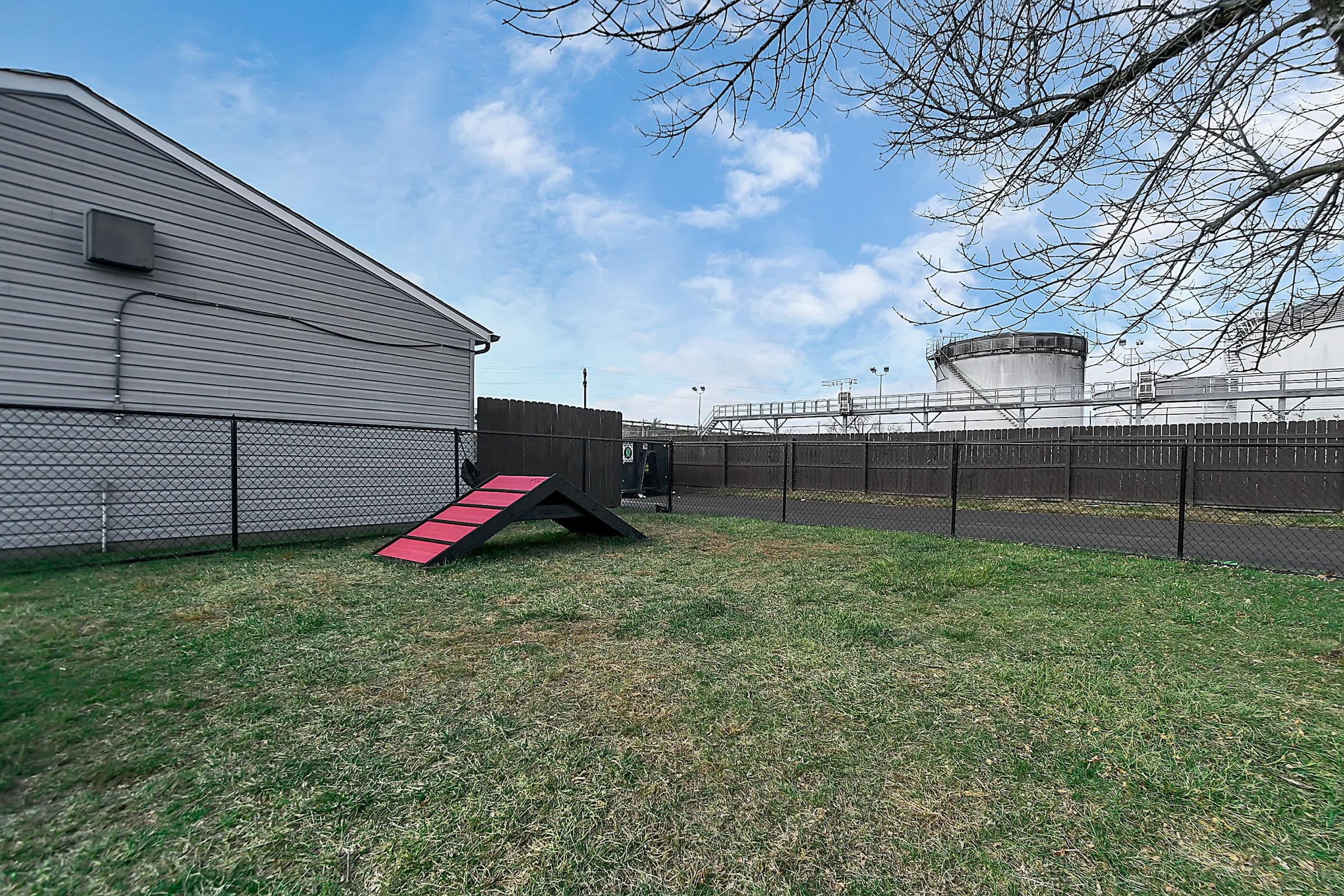 a large brick building with grass in front of a house