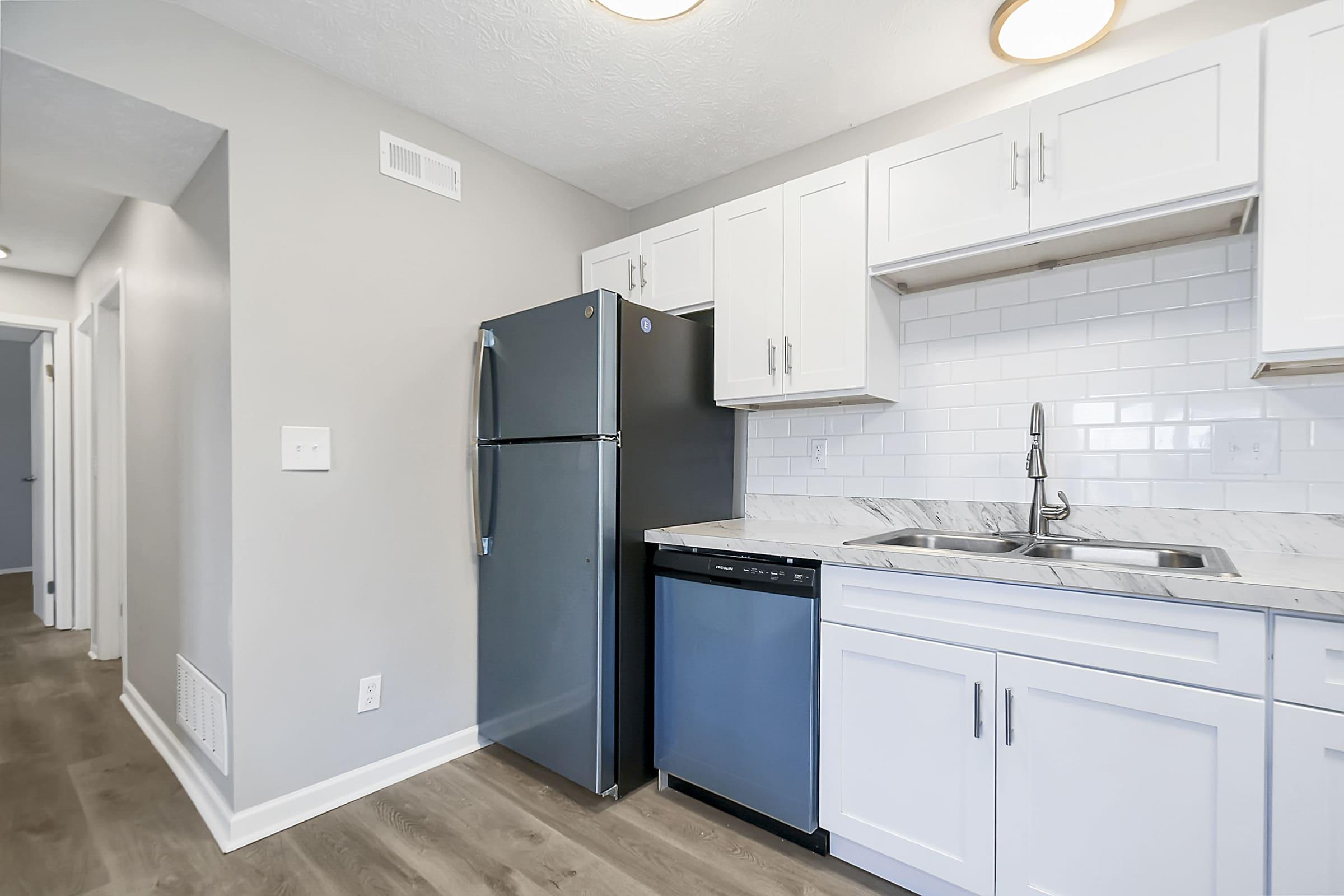 a kitchen with a sink and a refrigerator