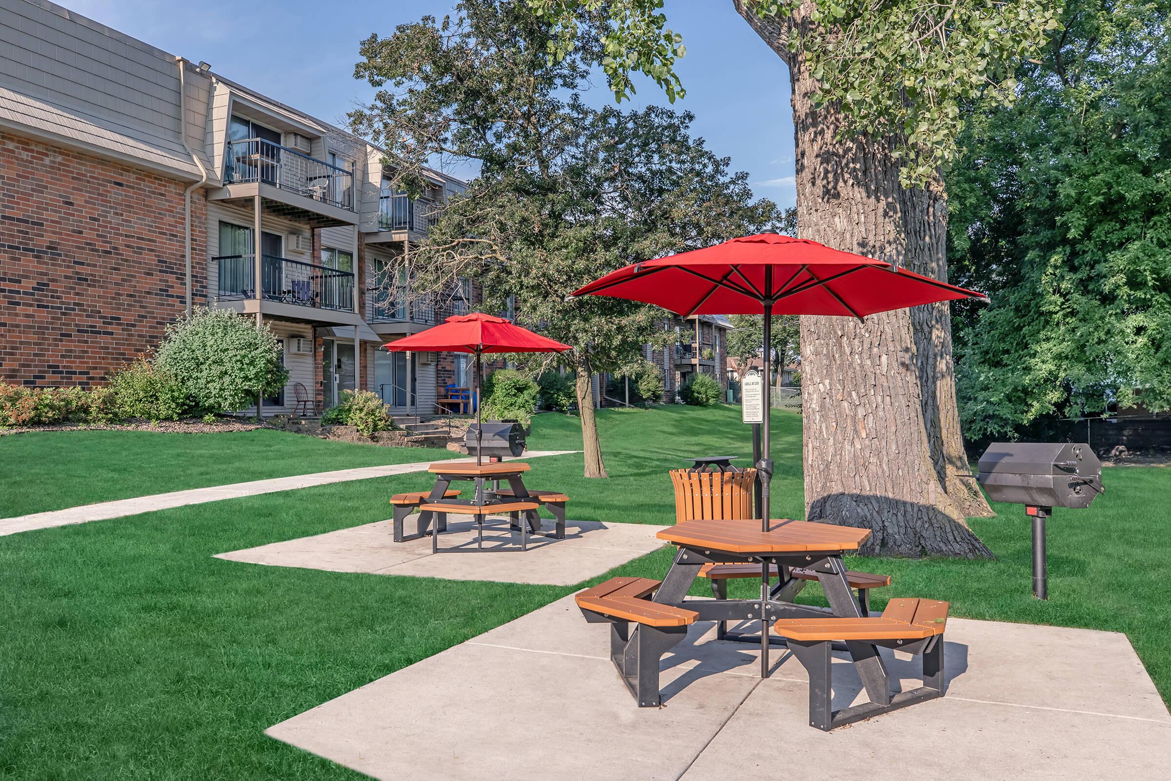 a group of lawn chairs sitting on top of a picnic table